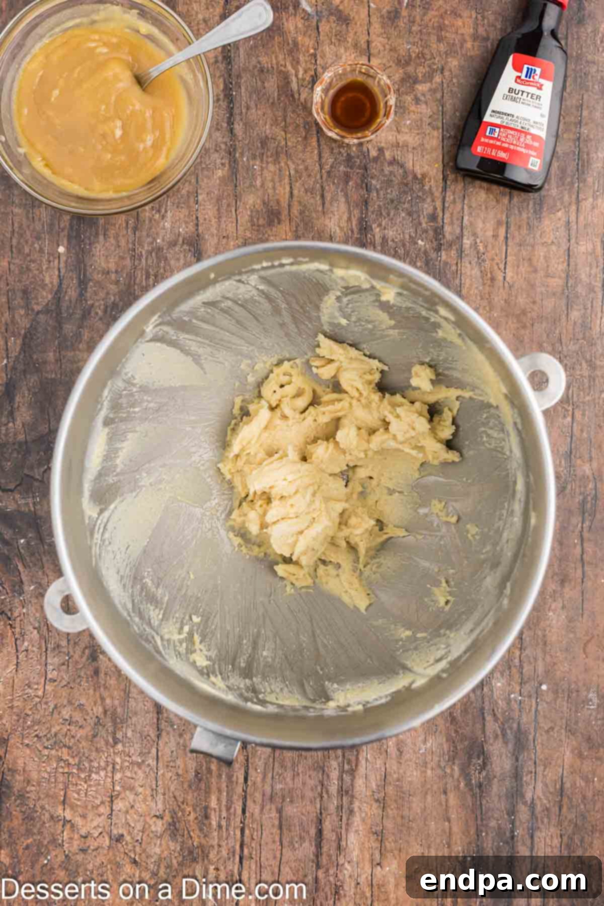 Softened butter and brown sugar being beaten until light and fluffy in a stand mixer.