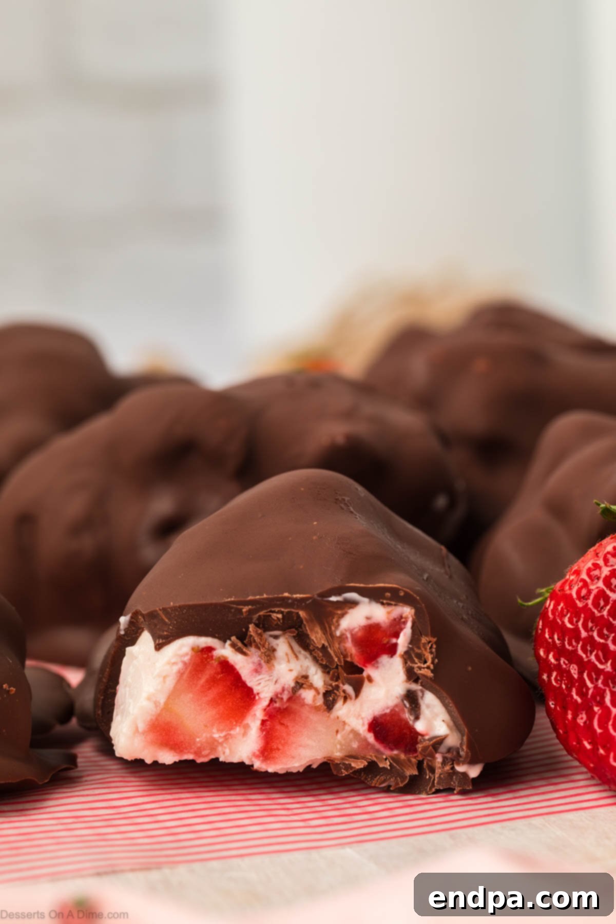 Freshly prepared Strawberry Yogurt Bites, perfectly frozen and ready to serve on a clean white surface.