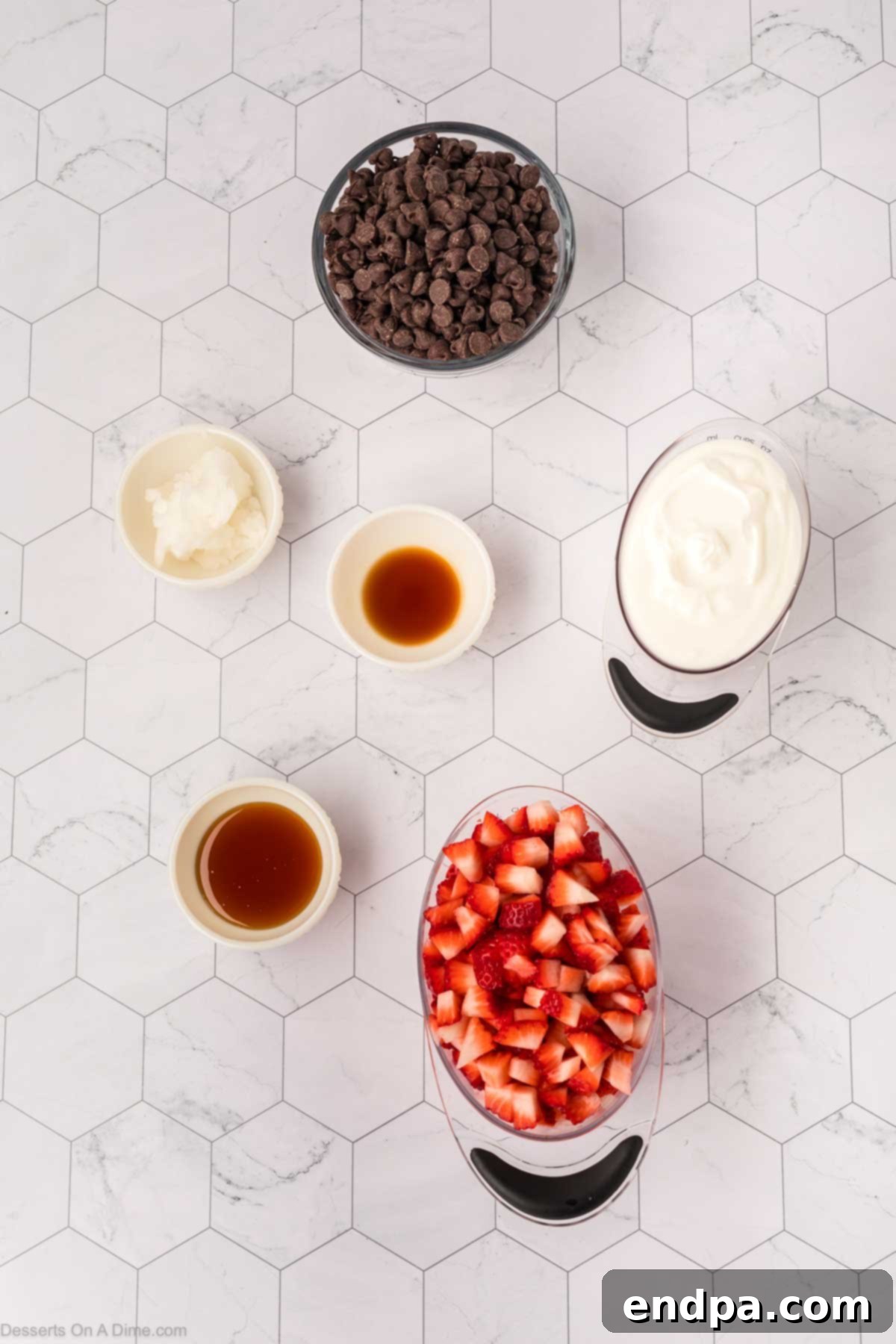 Ingredients for Strawberry Yogurt Bites laid out: fresh strawberries, Greek yogurt, honey or maple syrup, vanilla extract, semi-sweet chocolate chips, and coconut oil.