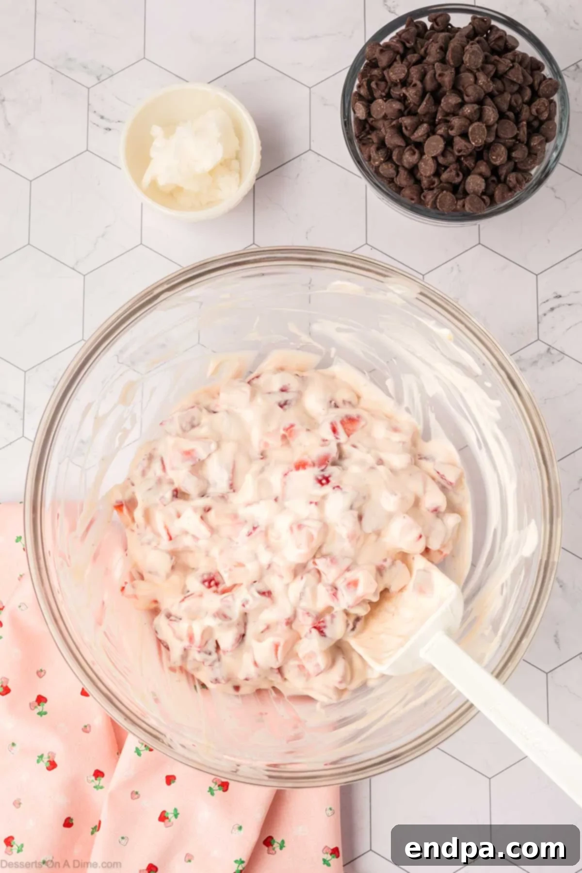 The yogurt mixture fully combined in a bowl, showing the consistency and distribution of strawberries.