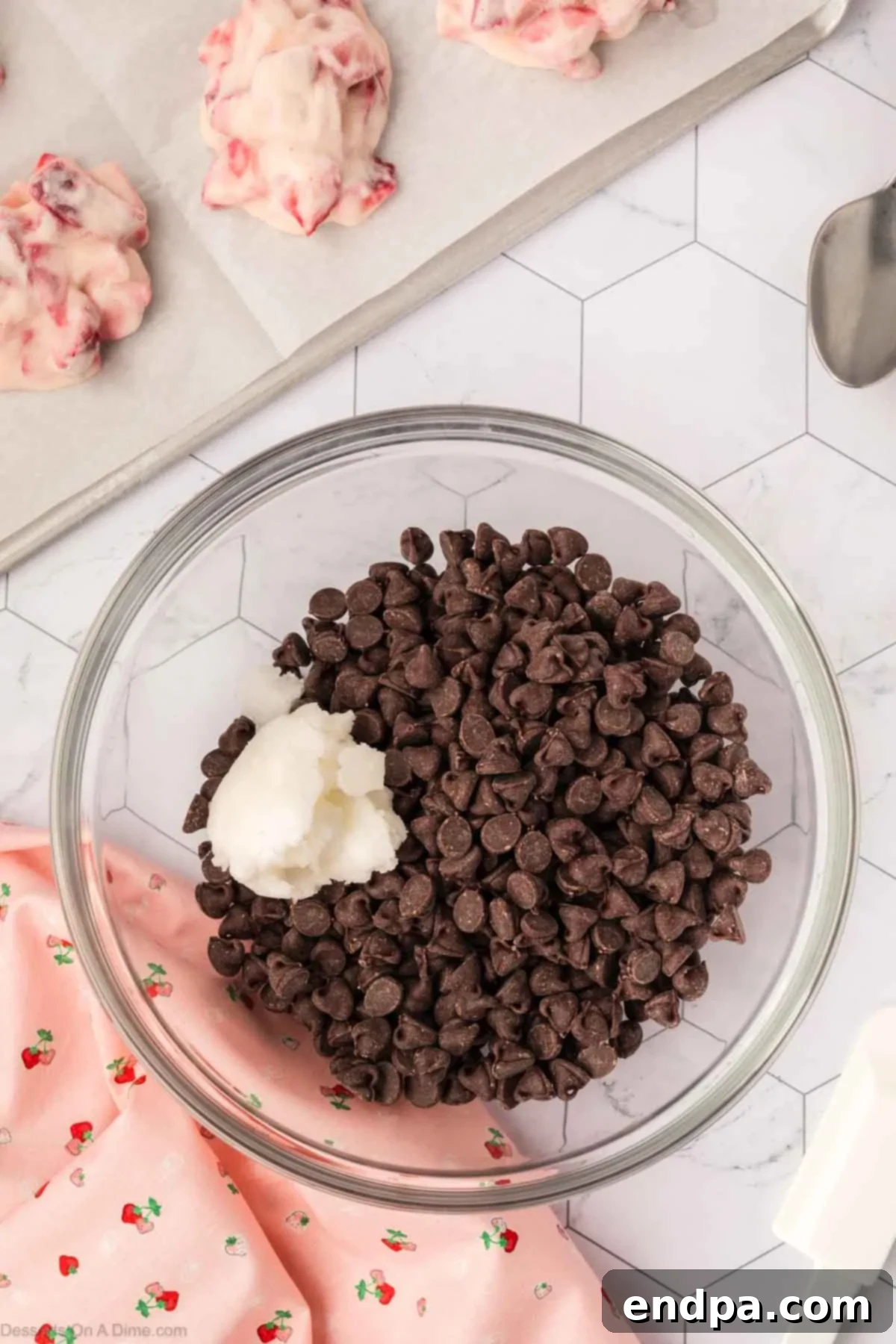 Semi-sweet chocolate chips and coconut oil in a microwave-safe bowl, before melting.
