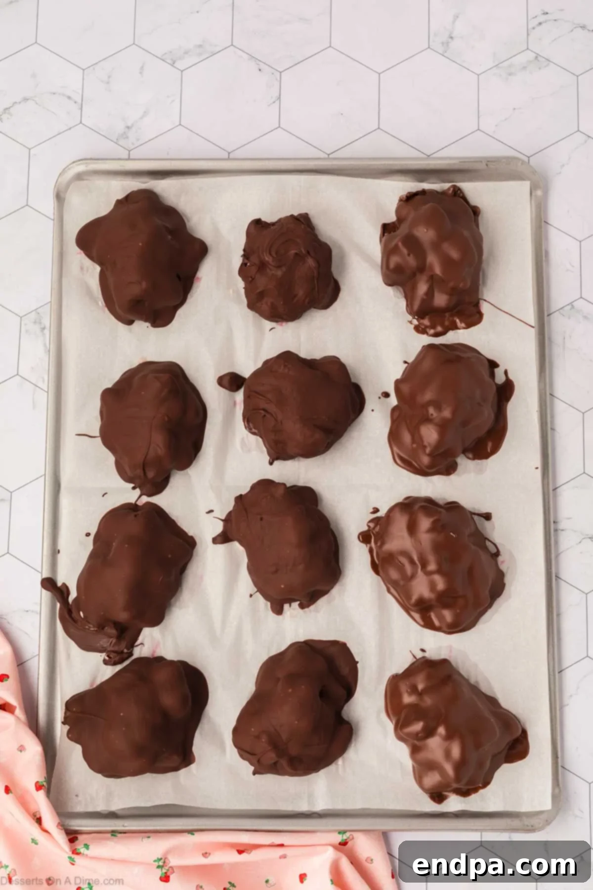 Chocolate-covered yogurt clusters placed back on the baking sheet for the chocolate to set.
