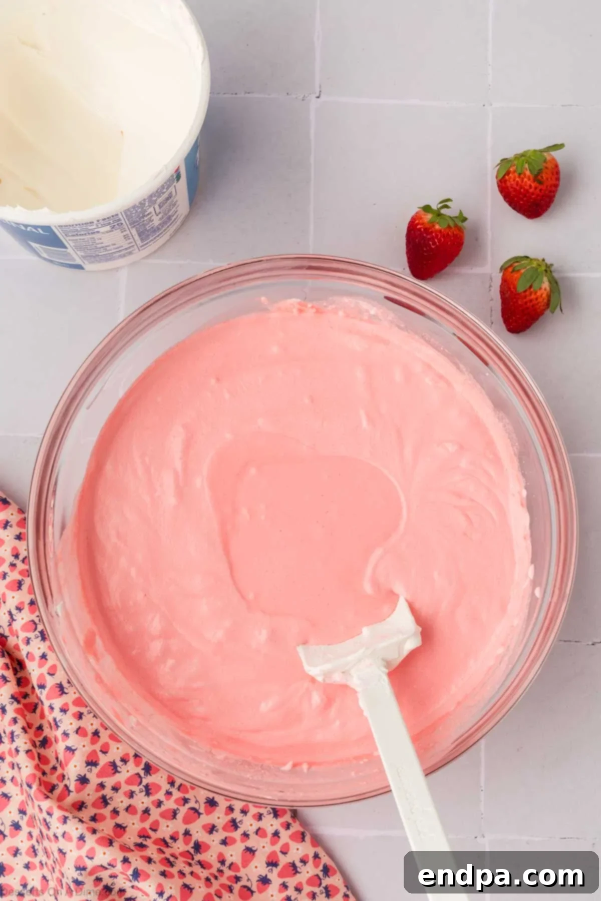 The smooth, creamy strawberry mousse mixture in a bowl after combining Jello and Cool Whip.