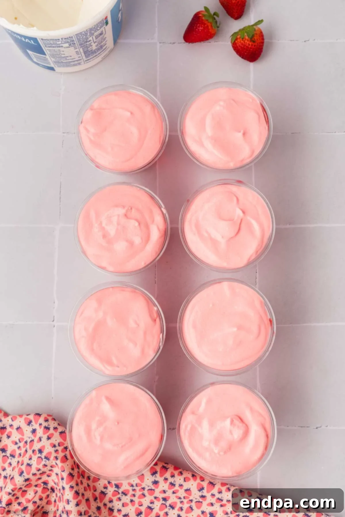 Cups filled with the first Jello layer, now upright, ready for the mousse layer.