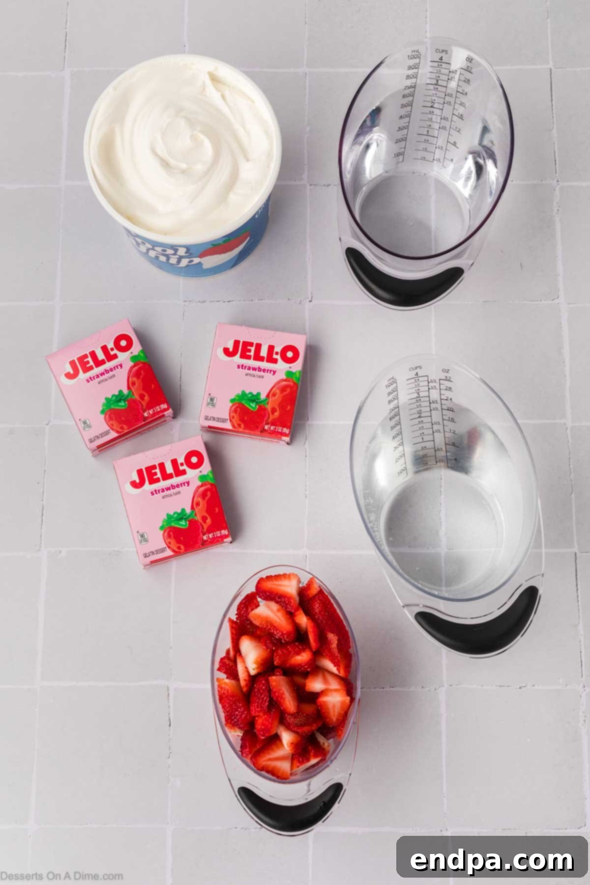 Ingredients for Jello Parfait including strawberry jello mix, water, Cool Whip, and fresh strawberries.