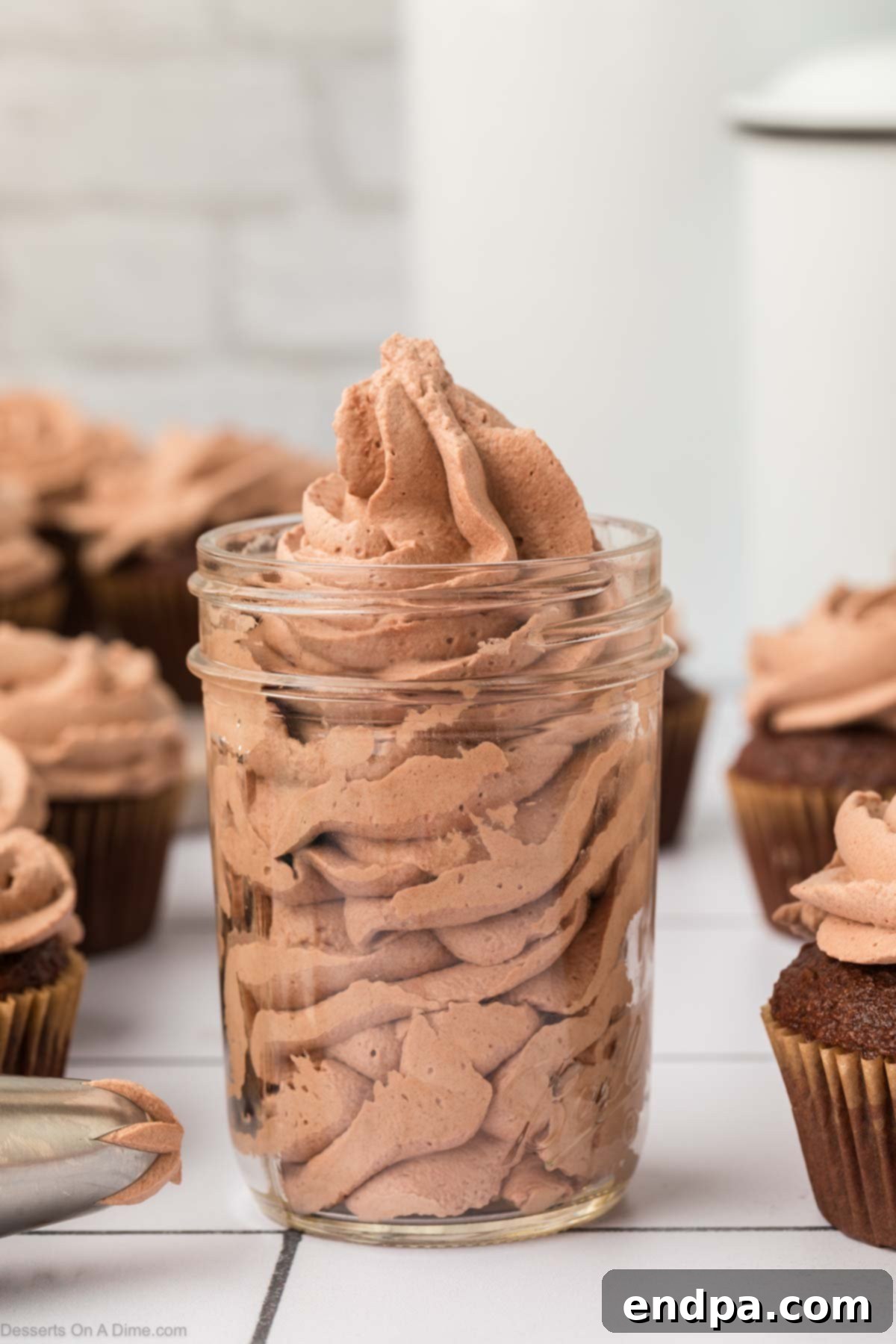 Light & Luscious Chocolate Frosting 2 Chocolate Whipped Cream Frosting in a jar, showcasing its smooth and inviting texture.