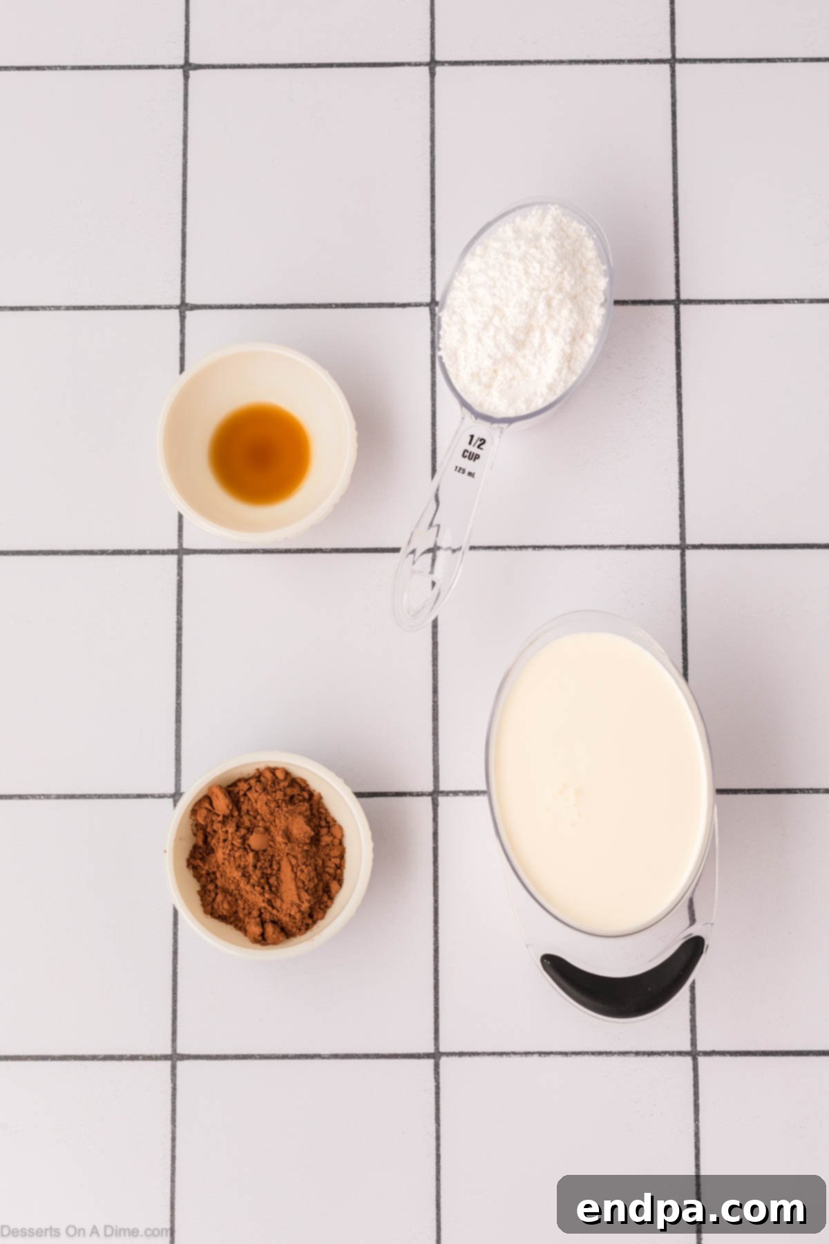 Light & Luscious Chocolate Frosting 3 Ingredients for Chocolate Whipped Cream Frosting - heavy cream, cocoa powder, powdered sugar, vanilla extract displayed on a wooden board.