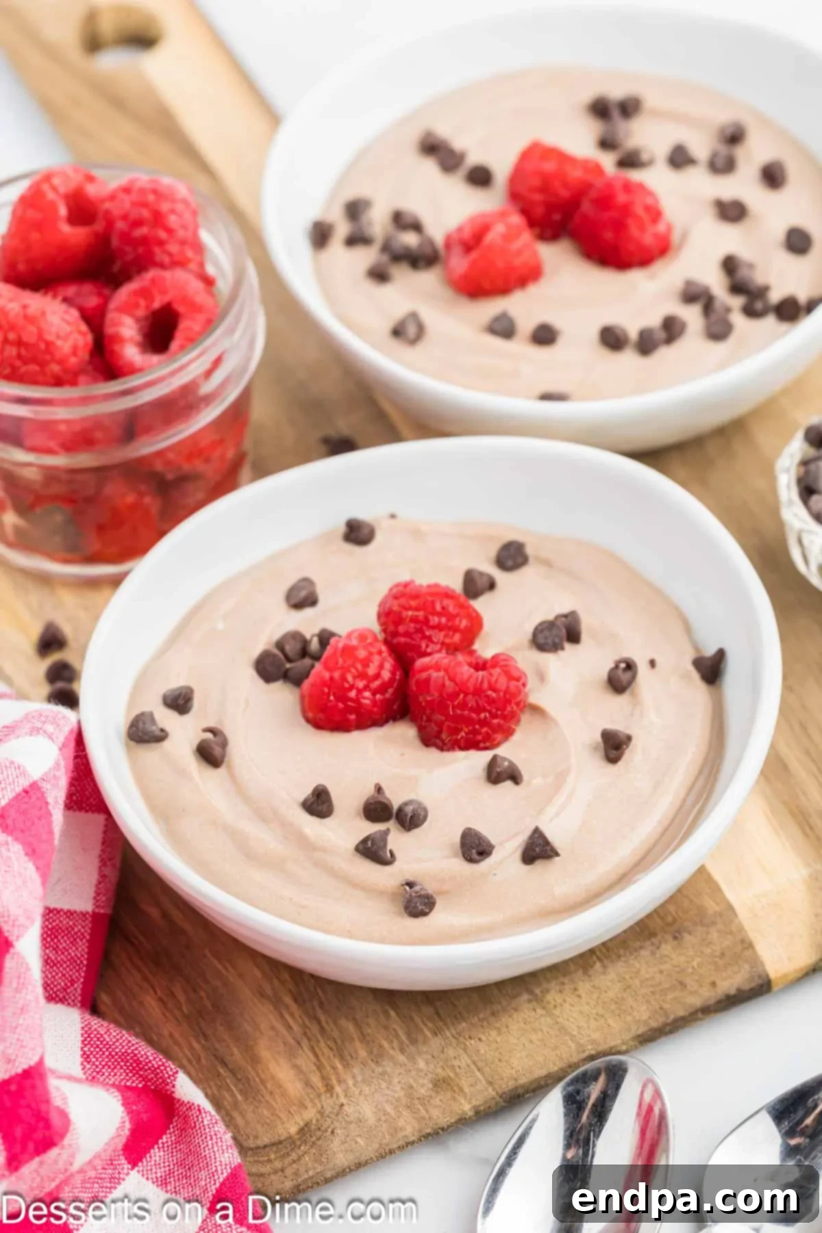 Wholesome Curd Delight 2 Two bowls of creamy Chocolate Cottage Cheese Pudding garnished with fresh berries and chocolate shavings.