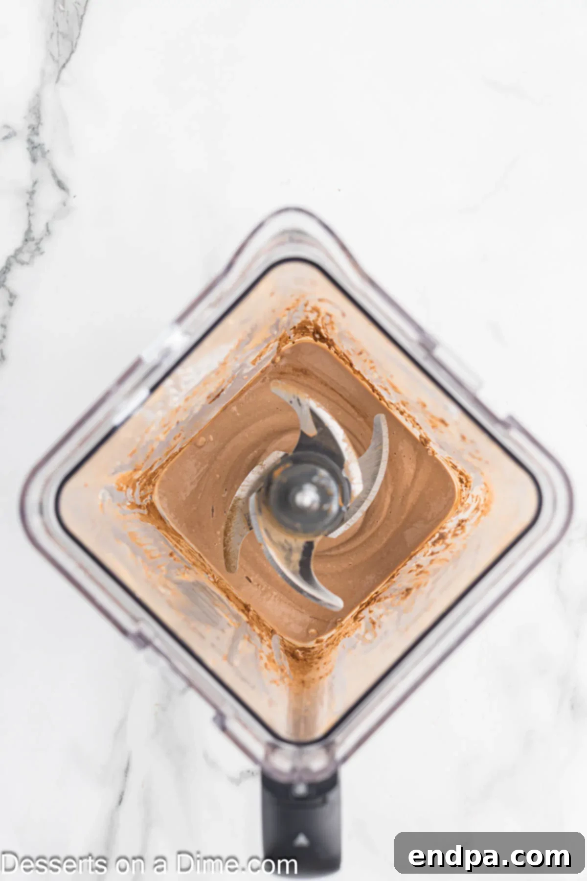 Wholesome Curd Delight 4 Cottage cheese, cocoa powder, and maple syrup are all added into a blender, ready to be processed into pudding.