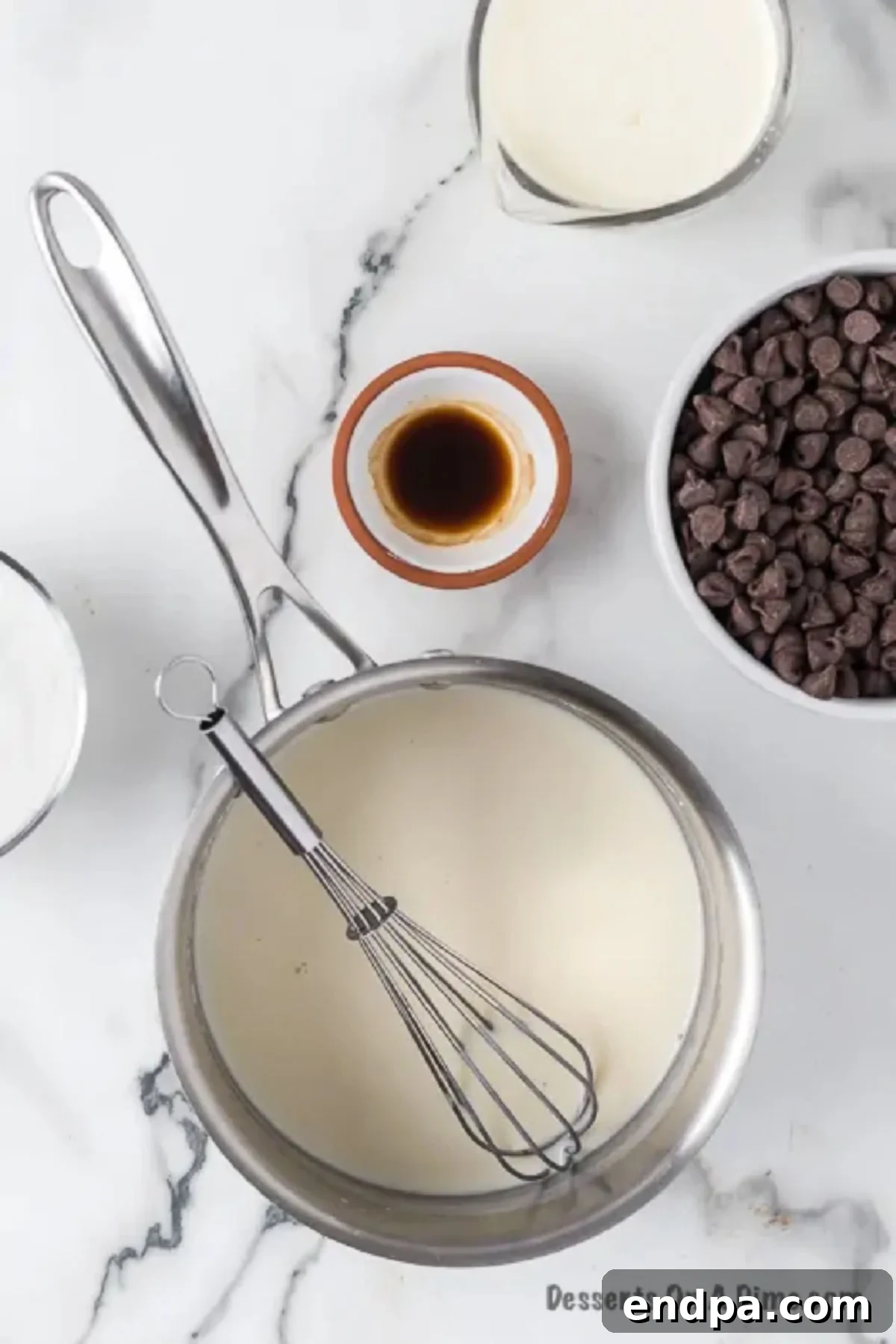 The milk and flour mixture in the saucepan has thickened into a smooth, cooked paste for the cream filling.