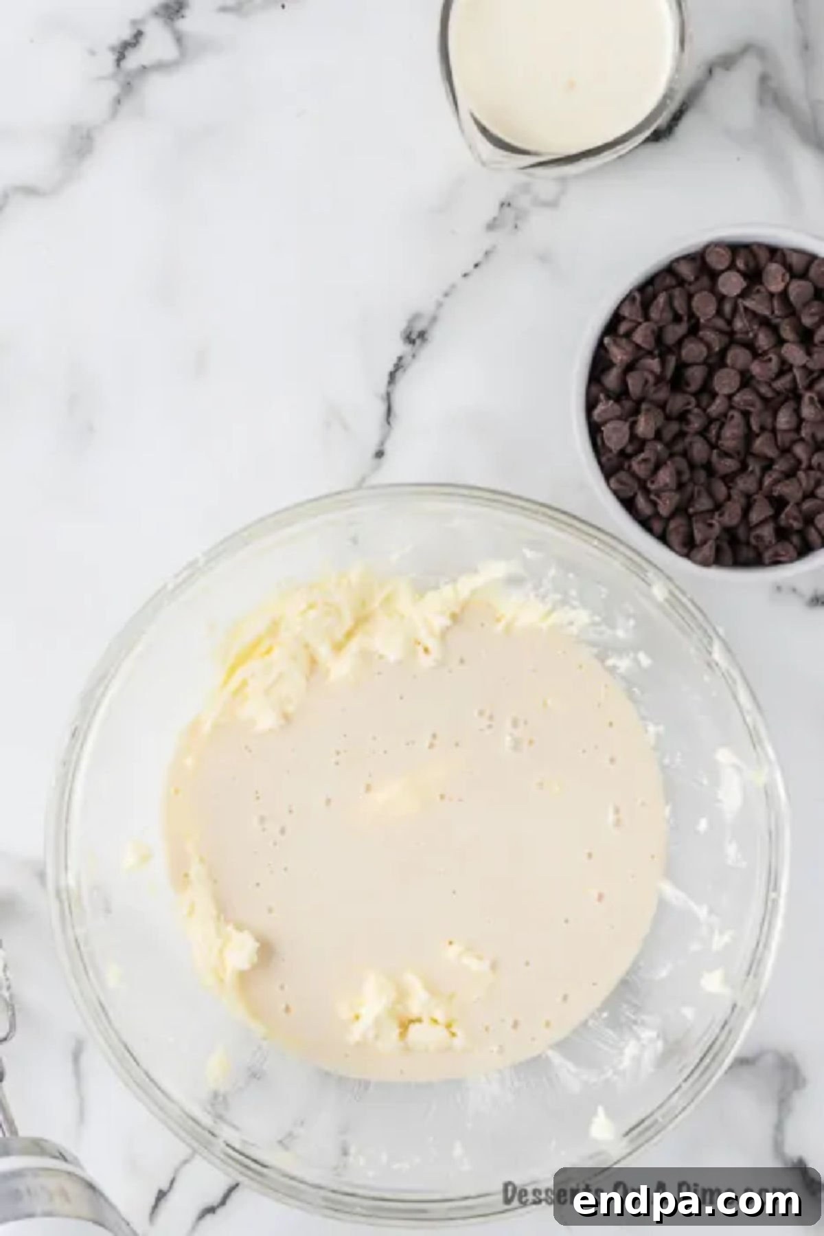 The cooled flour-milk paste combined with the creamed butter and sugar mixture, whipped to a light and fluffy consistency resembling whipped cream.