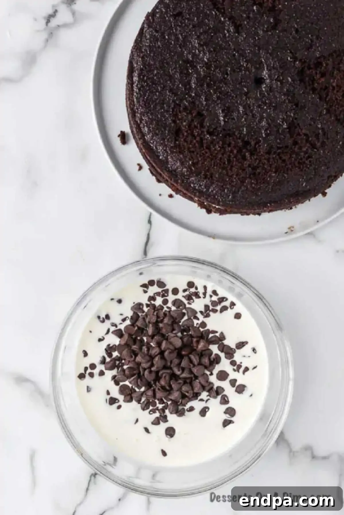 Chocolate chips and heavy whipping cream in a bowl, ready to be microwaved to make the ganache.