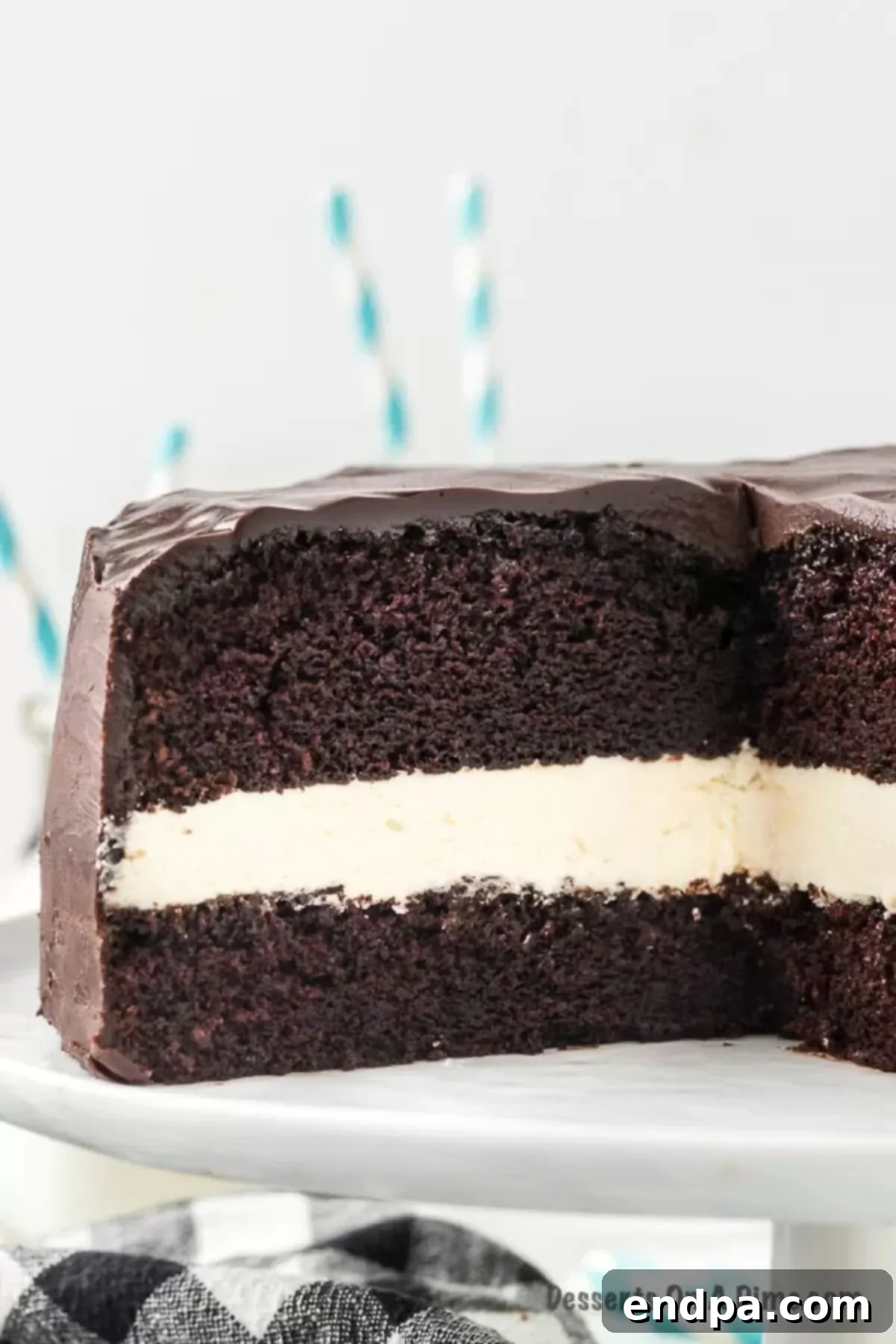 The assembled Ding Dong Cake with both chocolate cake layers, cream filling, and a fresh pour of glossy chocolate ganache covering the top and sides.