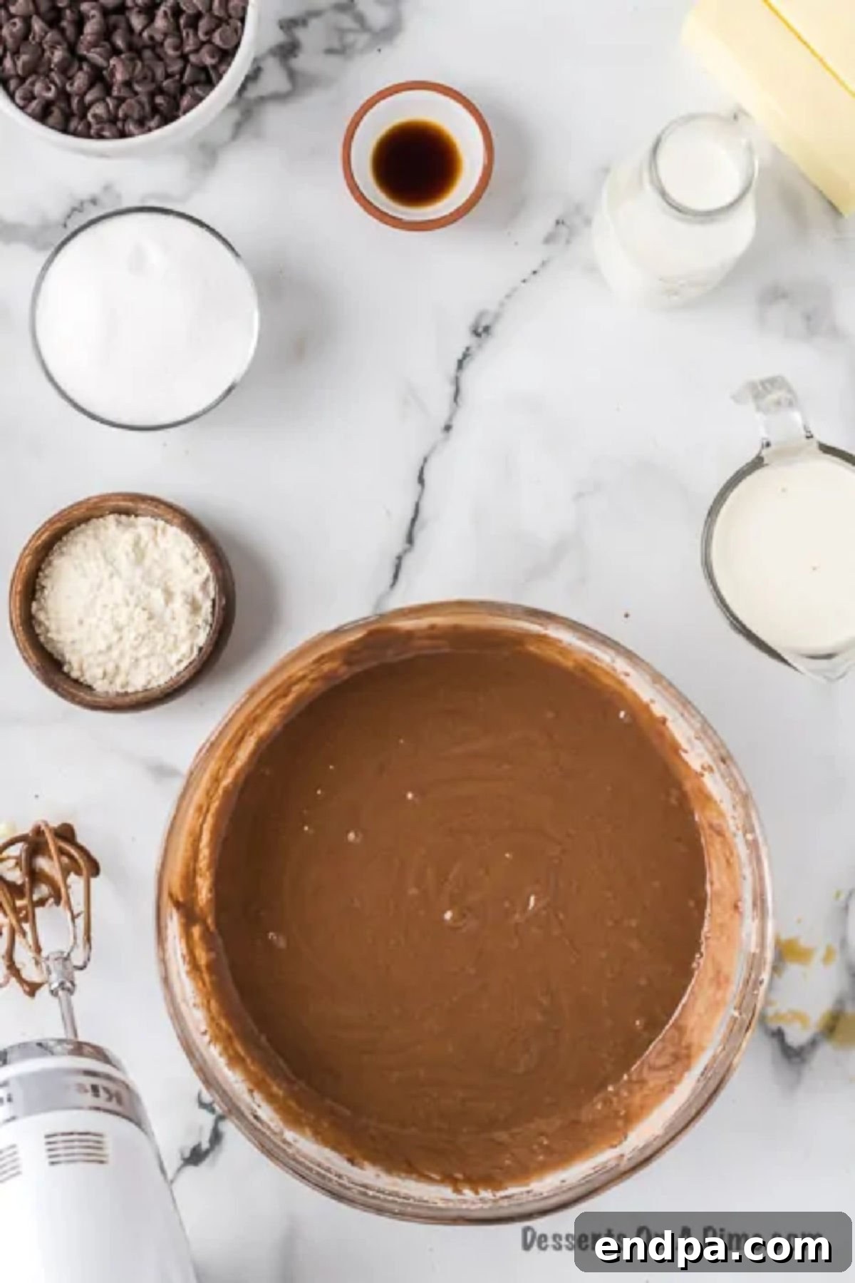 The fully combined cake batter, smooth and consistent, in a mixing bowl.
