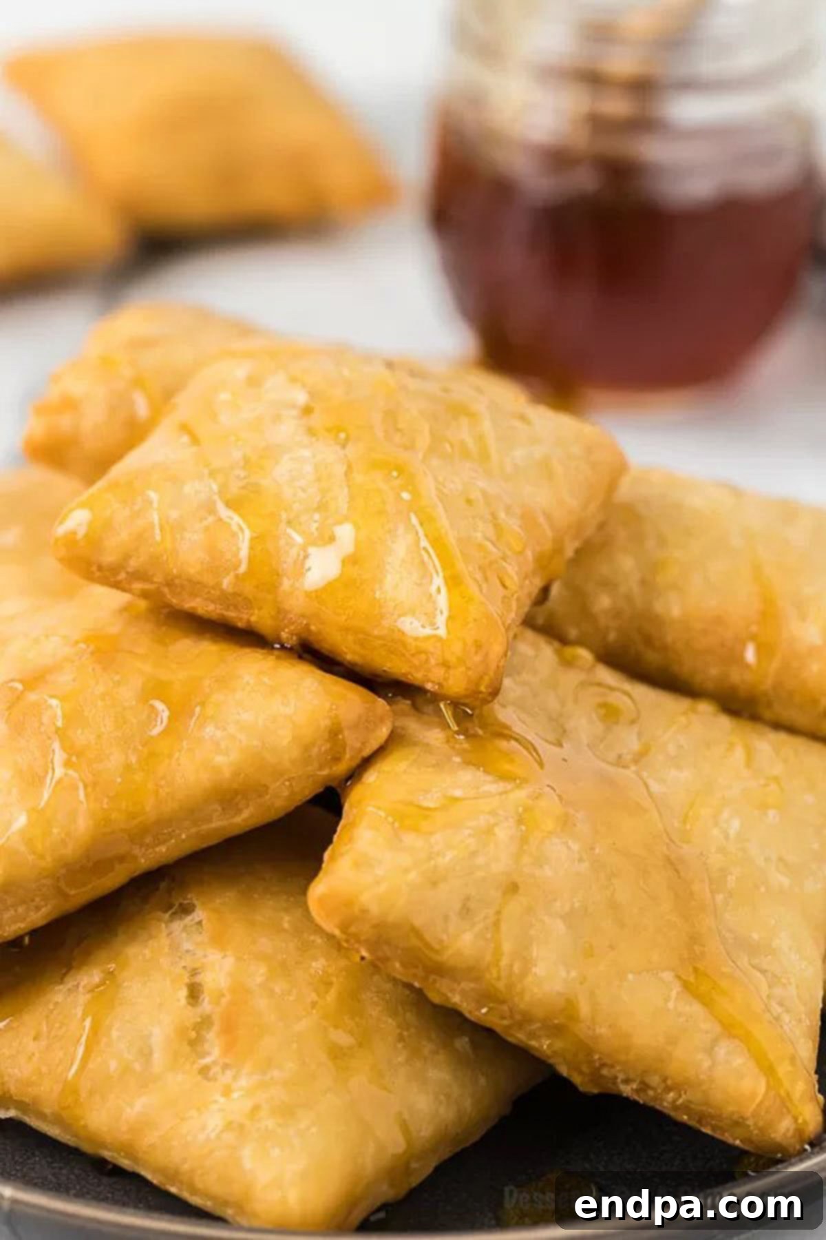 Sopapillas on plate with honey. 