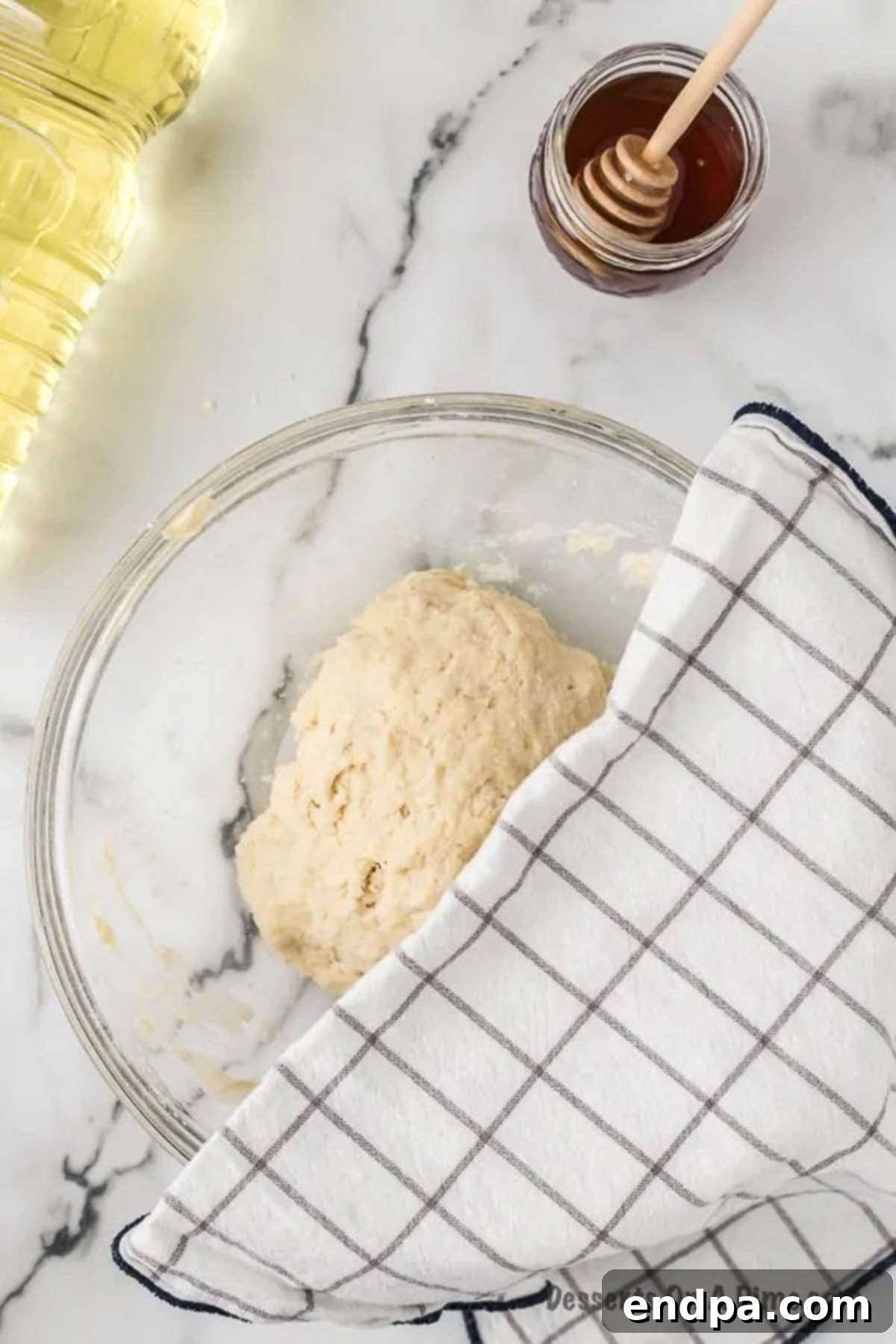 Towel covering dough on bowl. 