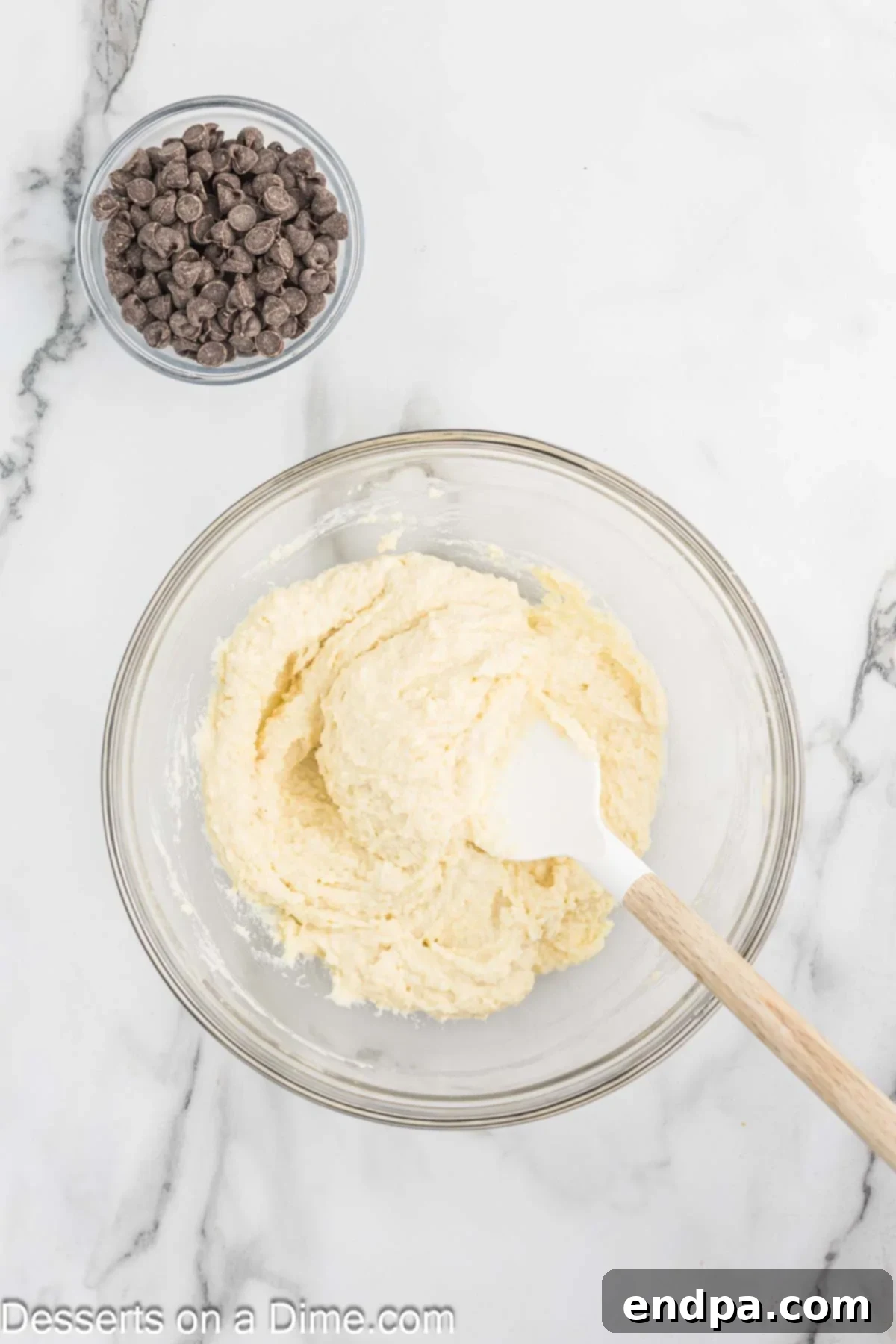 Monk fruit sweetener, almond flour, and vanilla protein powder added to the blended cottage cheese and egg mixture in a bowl.