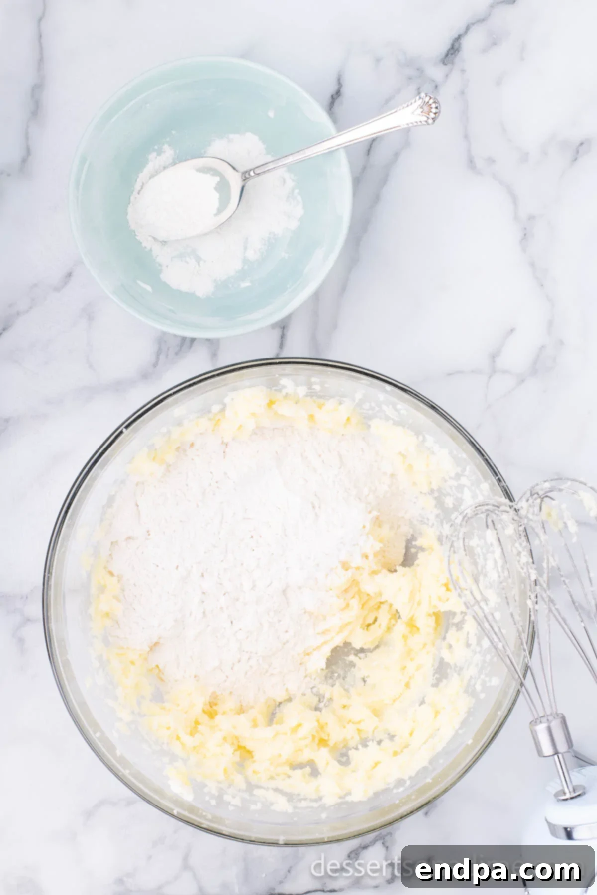 THUMBPRINT JAM COOKIES 7 Mixing bowl with flour, butter, and sugar combined, forming a cohesive cookie dough.