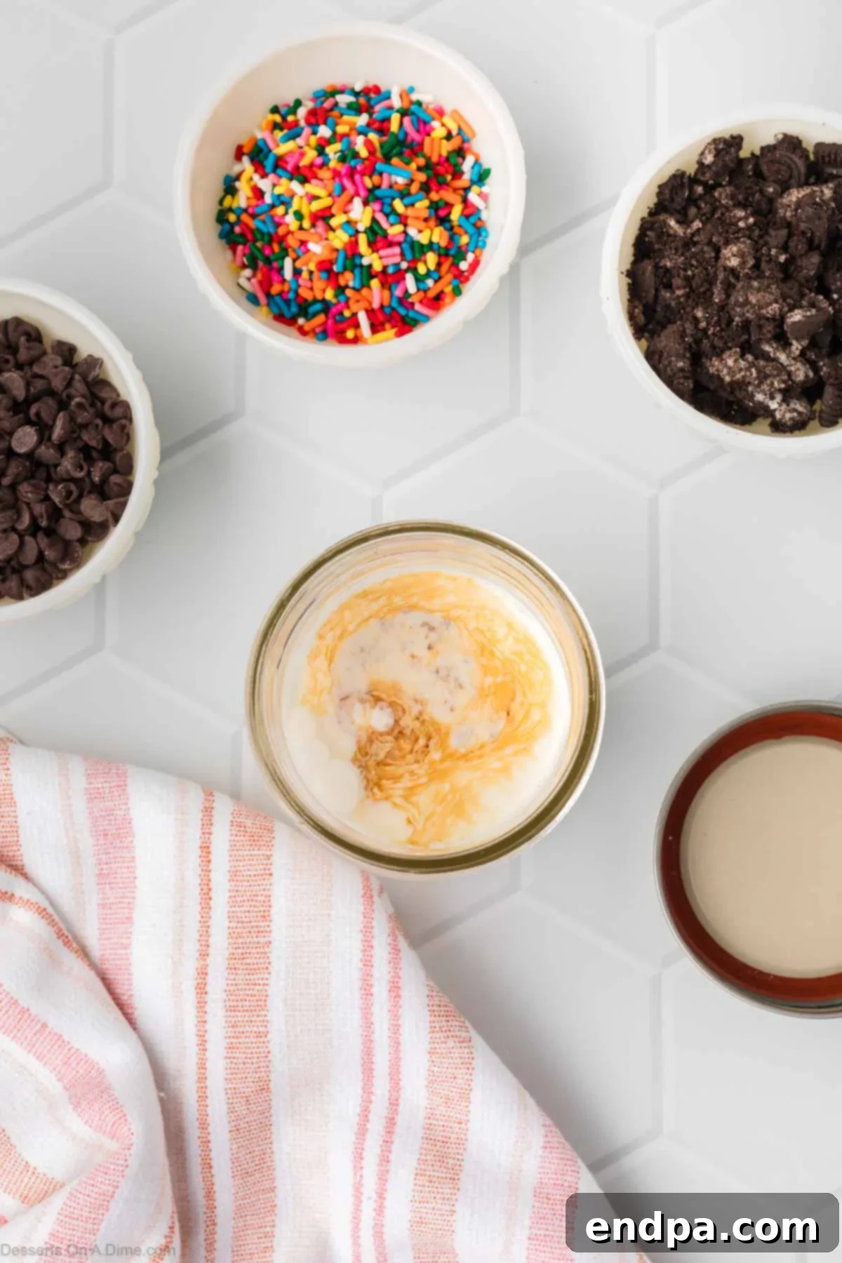 A mason jar filled with the ice cream mixture (heavy cream, sugar, vanilla, salt) before shaking, showing a smooth liquid consistency.