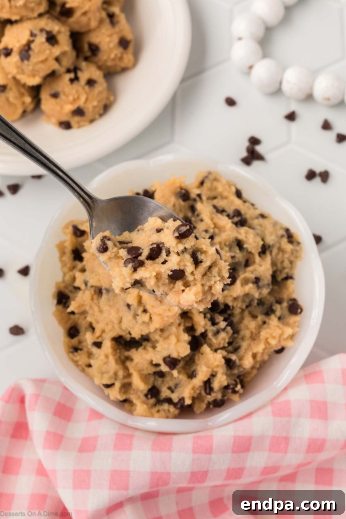 A bowl of creamy, high-protein Cottage Cheese Cookie Dough, generously mixed with mini chocolate chips, ready to be enjoyed. The texture is smooth and inviting.