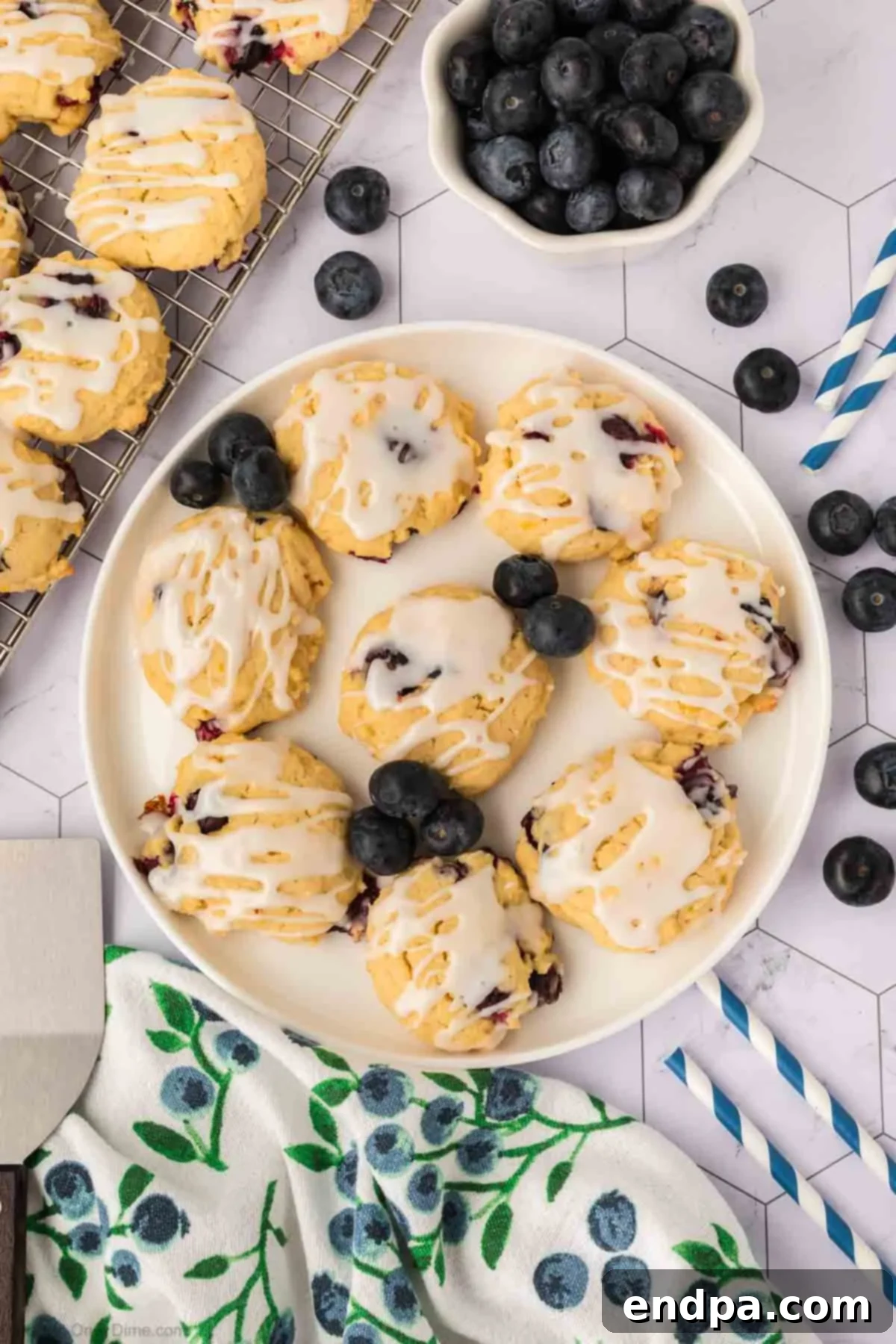 A beautiful platter of glazed lemon blueberry cookies, ready to be served, showcasing their vibrant color and inviting appeal.
