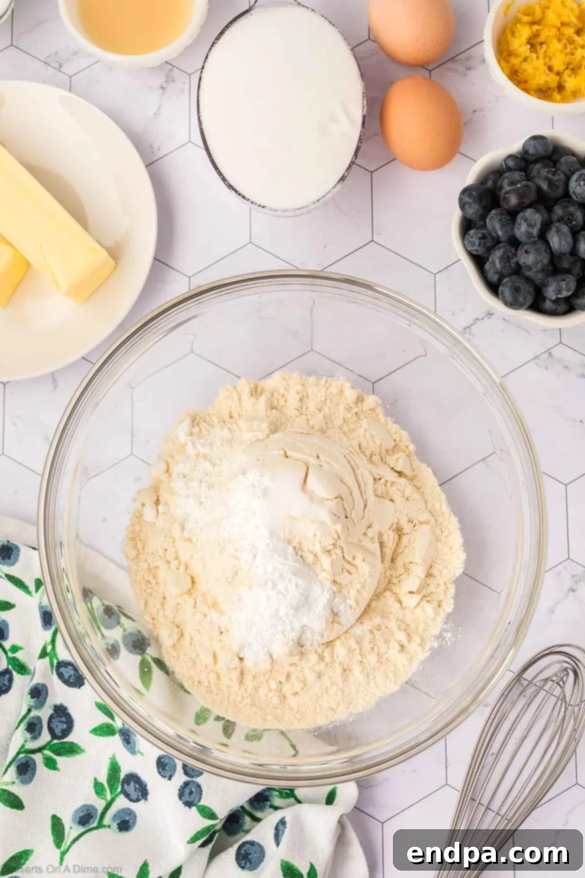 Dry ingredients for blueberry cookies, including flour, baking powder, cornstarch, and salt, perfectly combined in a large mixing bowl.