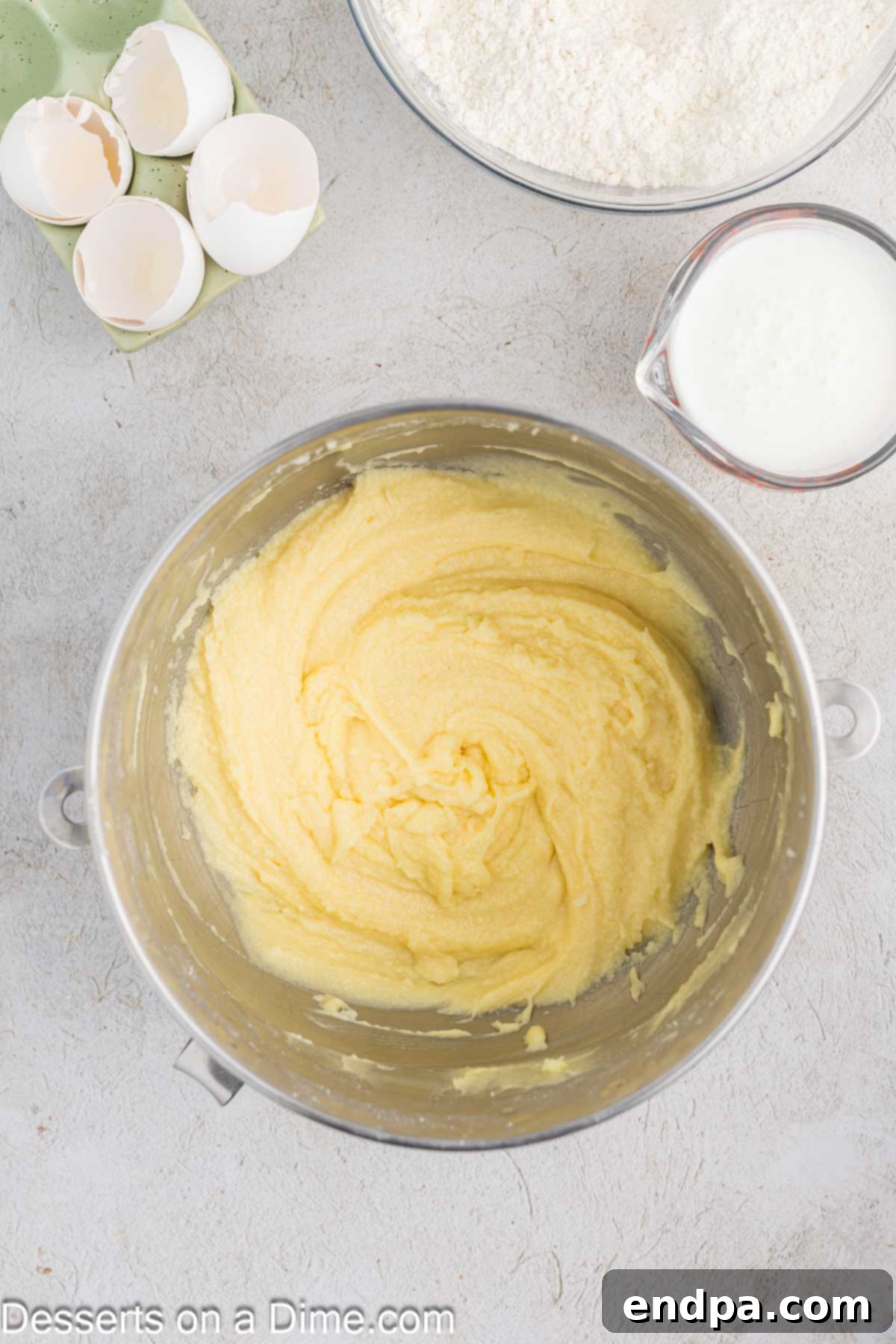 Softened butter and granulated sugar are creamed together in a stand mixer, creating a light and fluffy mixture.
