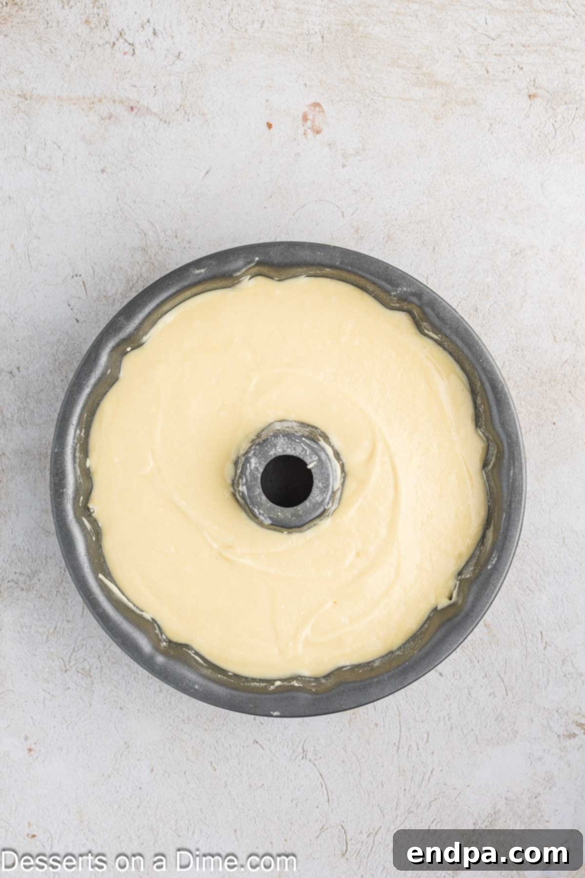The smooth cake batter is gently poured into the prepared bundt pan, ready for baking.