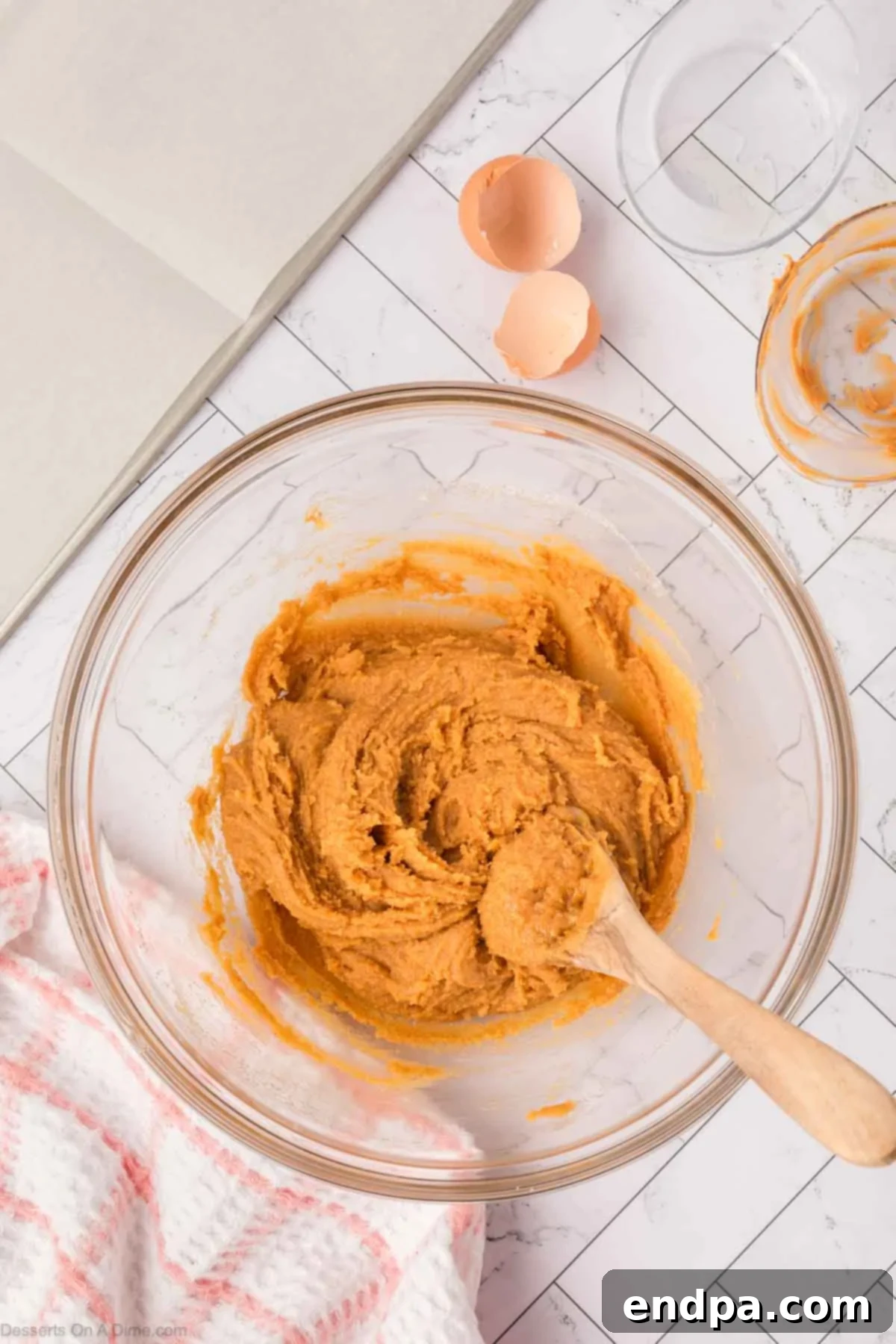 The three cookie ingredients fully combined into a smooth dough in a mixing bowl.
