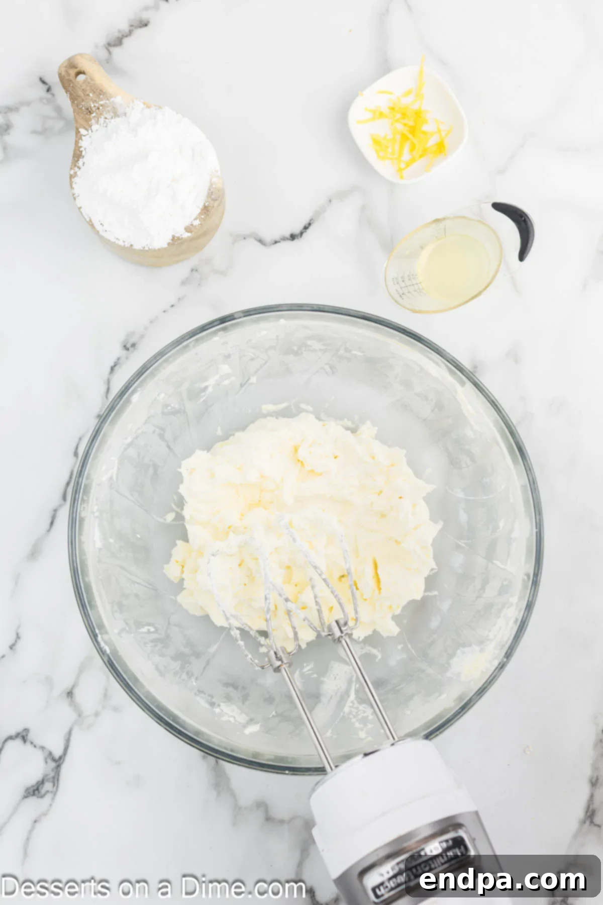 Lemon Berry Bliss 12 Cream cheese, butter, and powdered sugar being combined for the frosting.