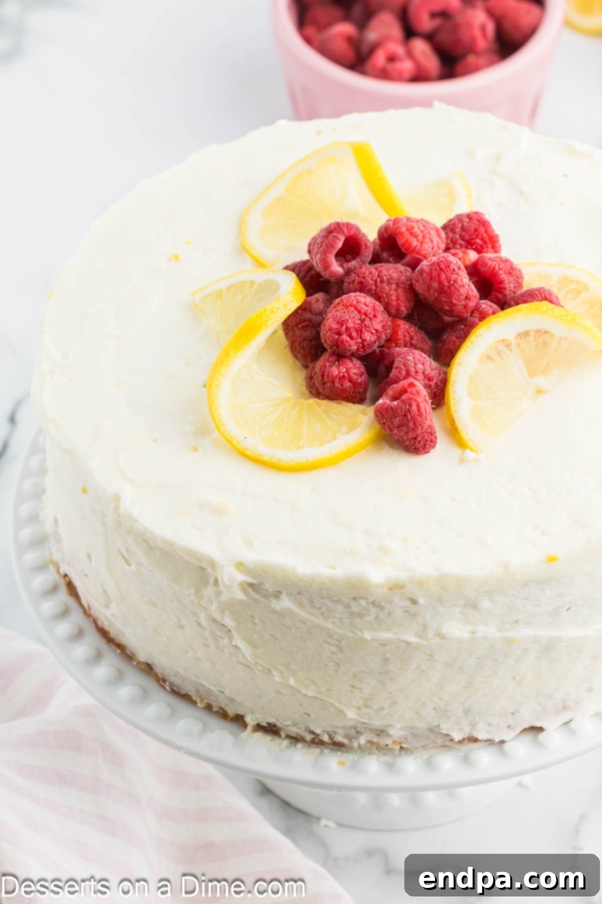 Lemon Berry Bliss 14 A two-layer lemon raspberry cake topped with a generous layer of frosting and fresh berries.