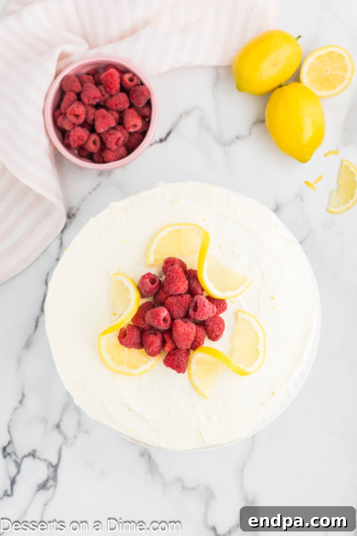 Lemon Berry Bliss 16 Beautifully decorated lemon raspberry cake topped with fresh fruit, ready to be served.