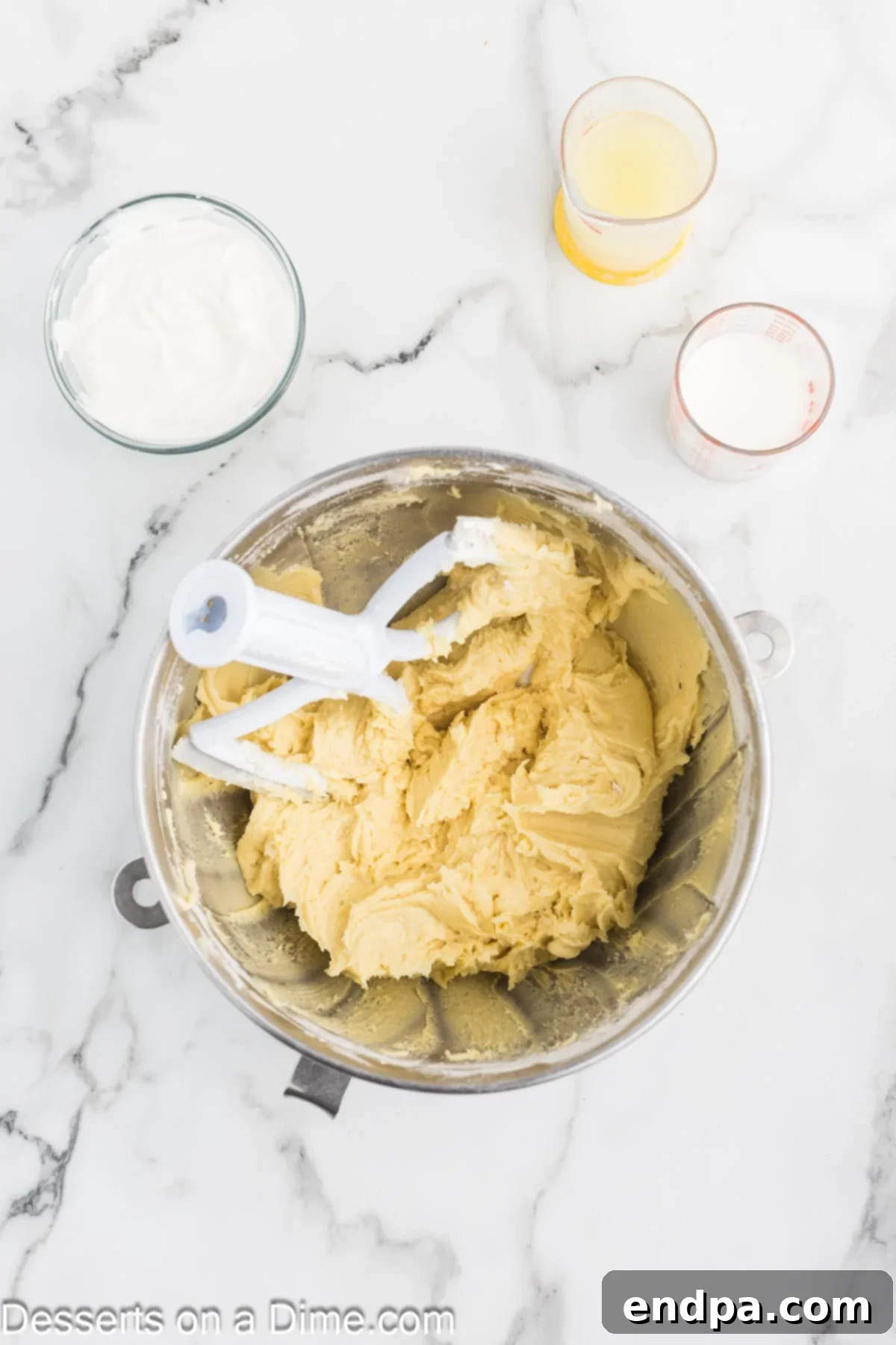 Lemon Berry Bliss 6 Eggs being added one at a time to the cake batter.