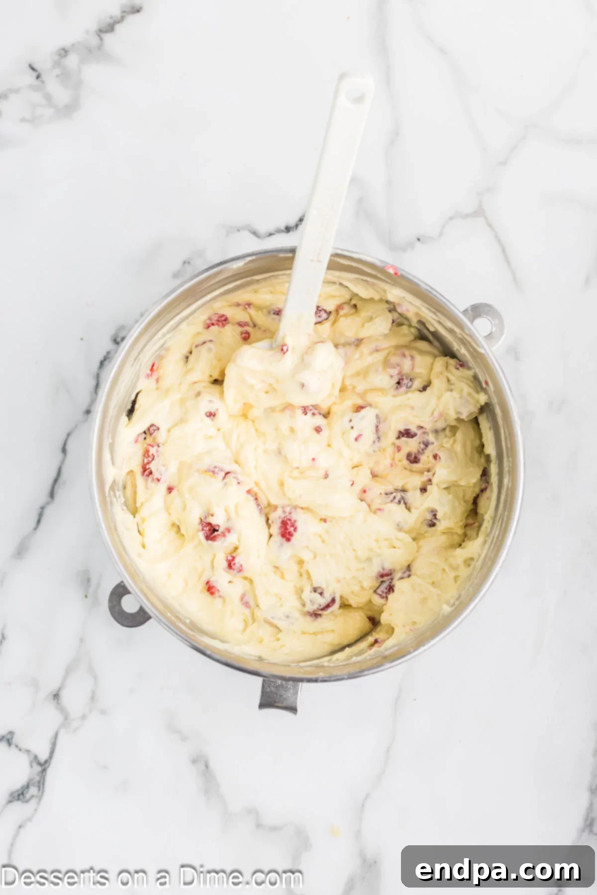 Lemon Berry Bliss 8 Fresh raspberries coated in flour being gently folded into the cake batter.