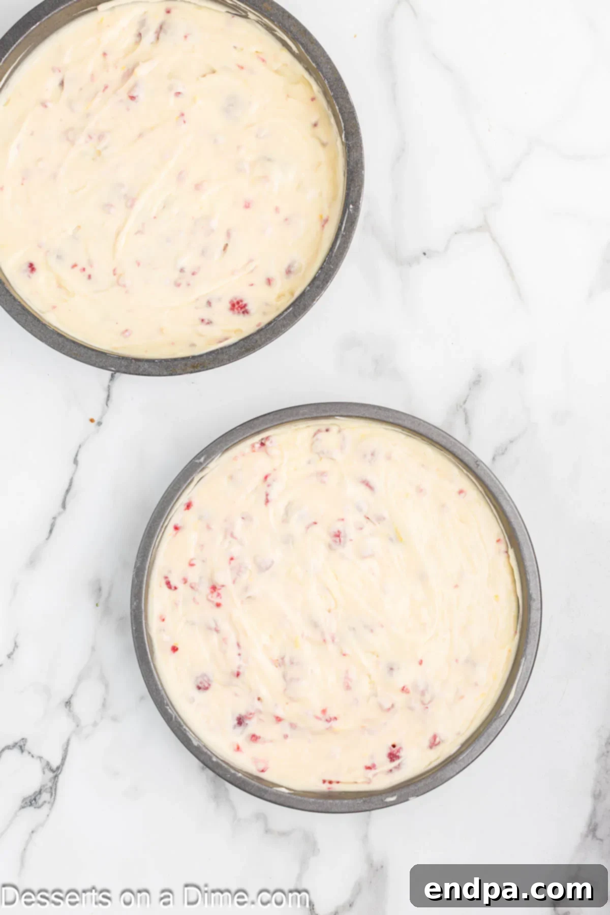Lemon Berry Bliss 9 Cake batter spread evenly into two prepared cake pans.