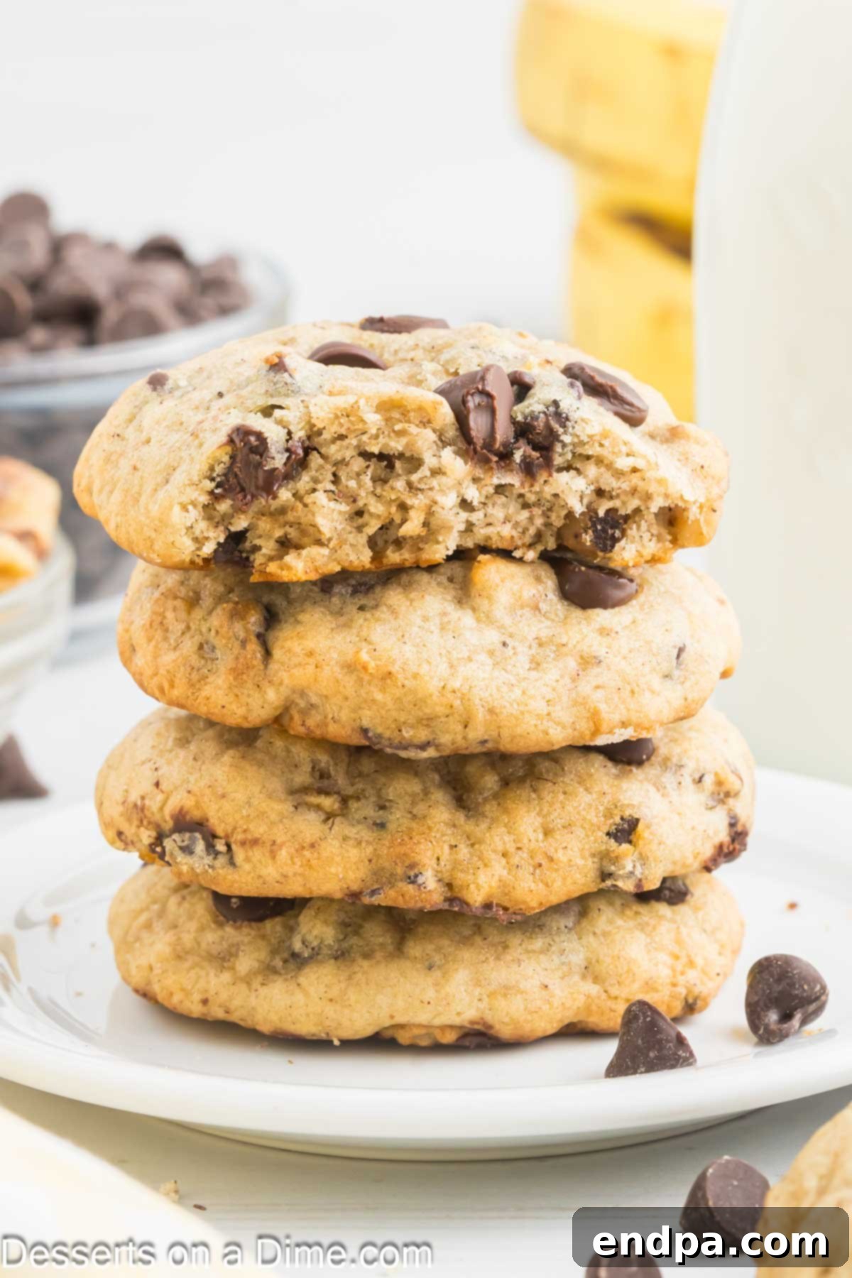 A stack of perfectly baked banana cookies on a platter, showcasing their soft texture and chocolate chips.