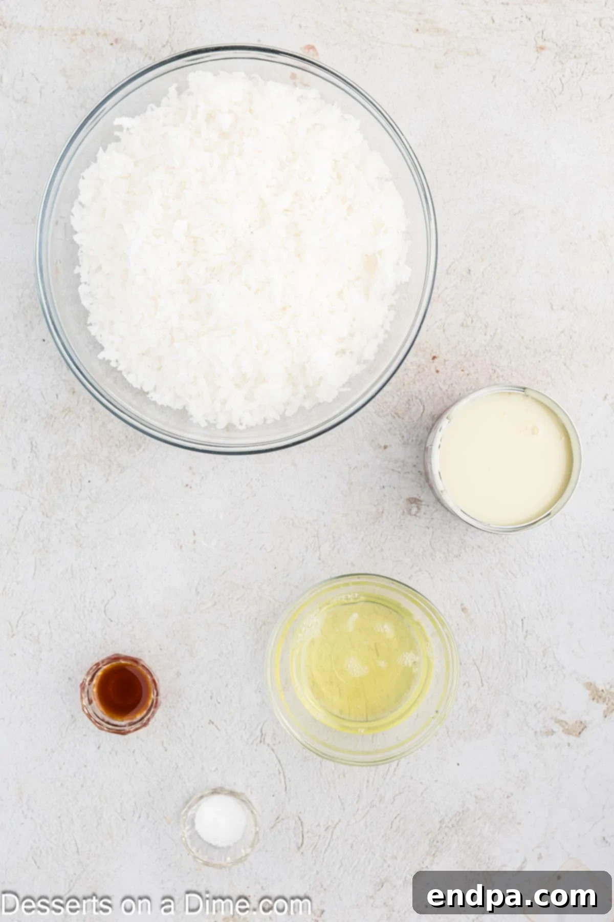 All five ingredients laid out for Macaroon Cookies: shredded coconut, sweetened condensed milk, vanilla extract, egg whites, and a pinch of salt.