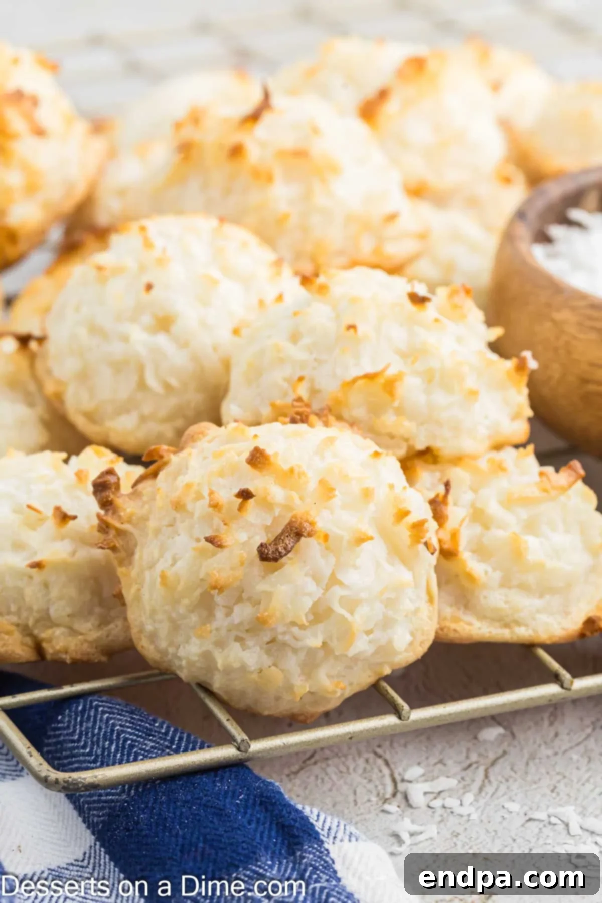 Freshly baked Coconut Macaroons cooling on a wire rack, ready for a chocolate drizzle or to be enjoyed plain.