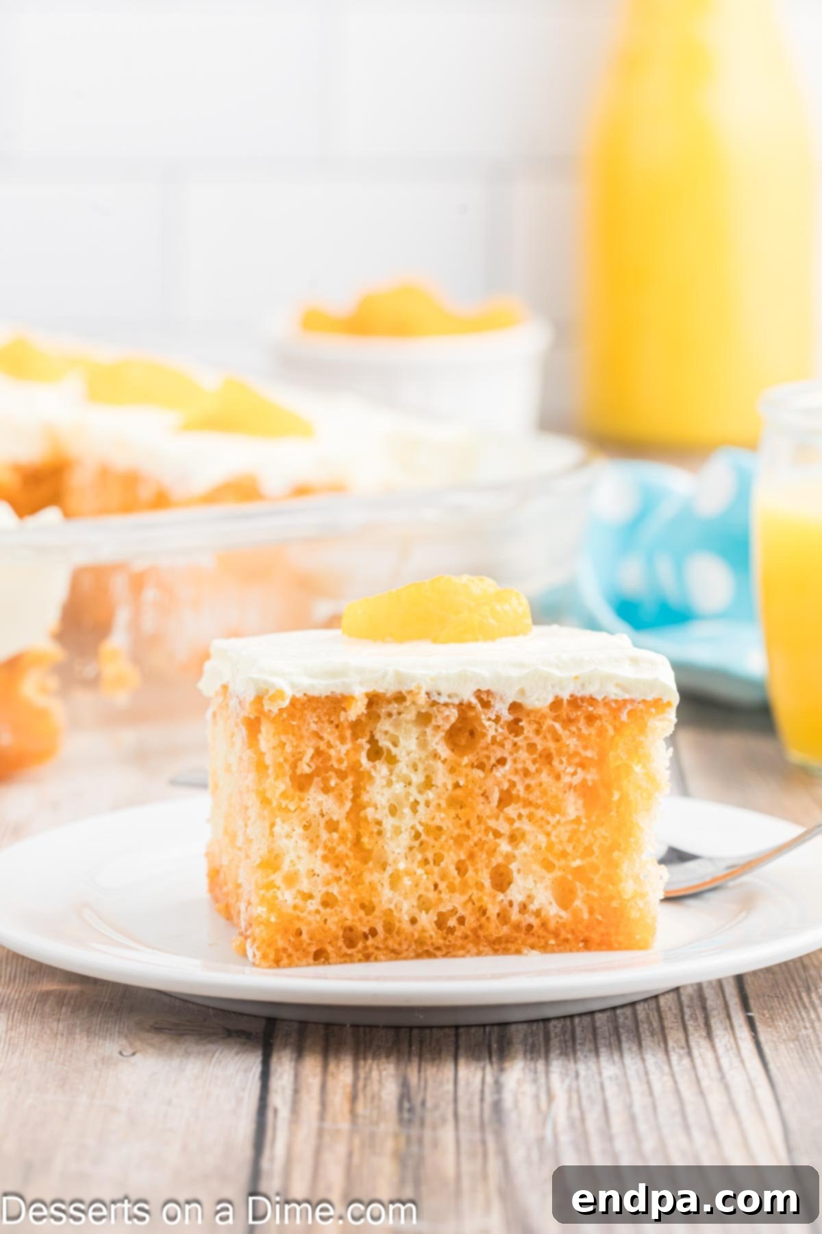 Velvet Orange Dream Cake 11 A freshly sliced piece of Orange Creamsicle Cake revealing its moist, orange-infused interior and creamy white frosting, ready to be served.