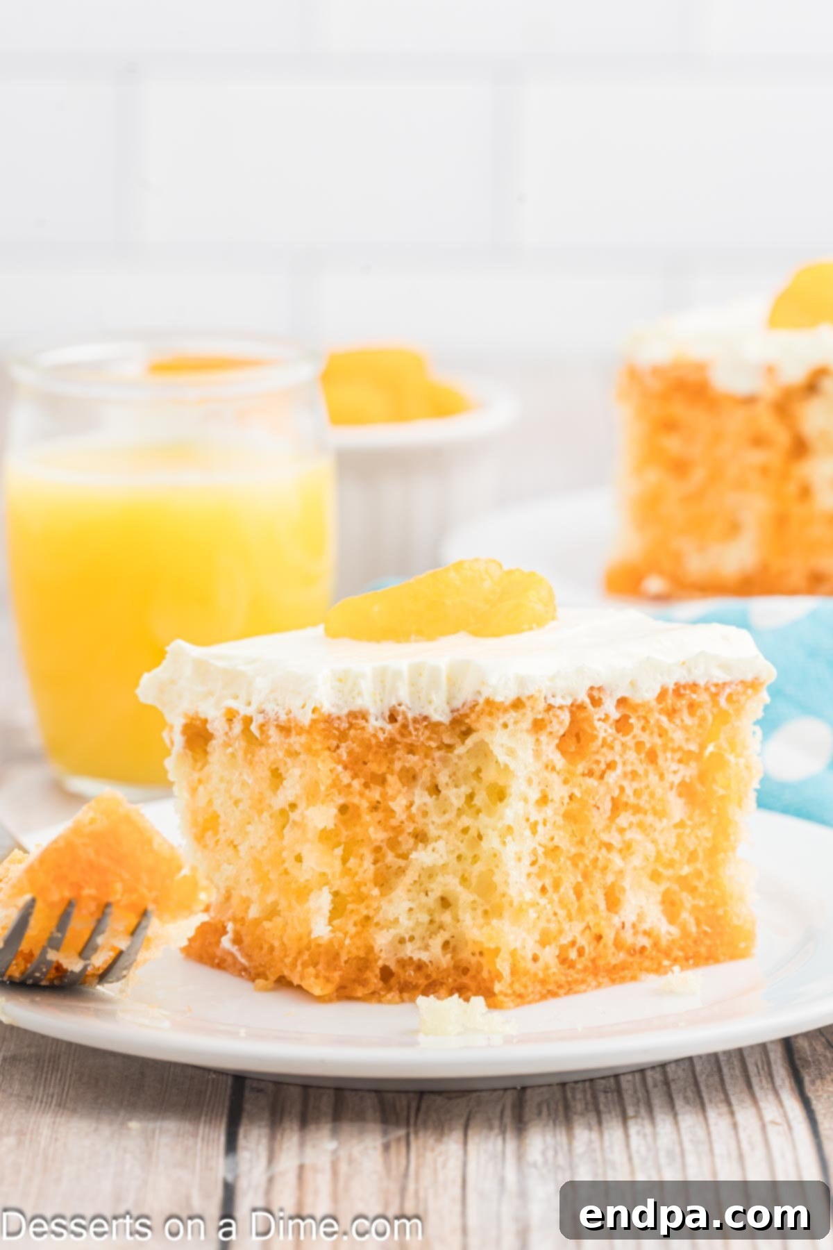 Velvet Orange Dream Cake 12 A generous slice of Orange Creamsicle Cake served on a white plate, highlighting its distinct orange and white layers.