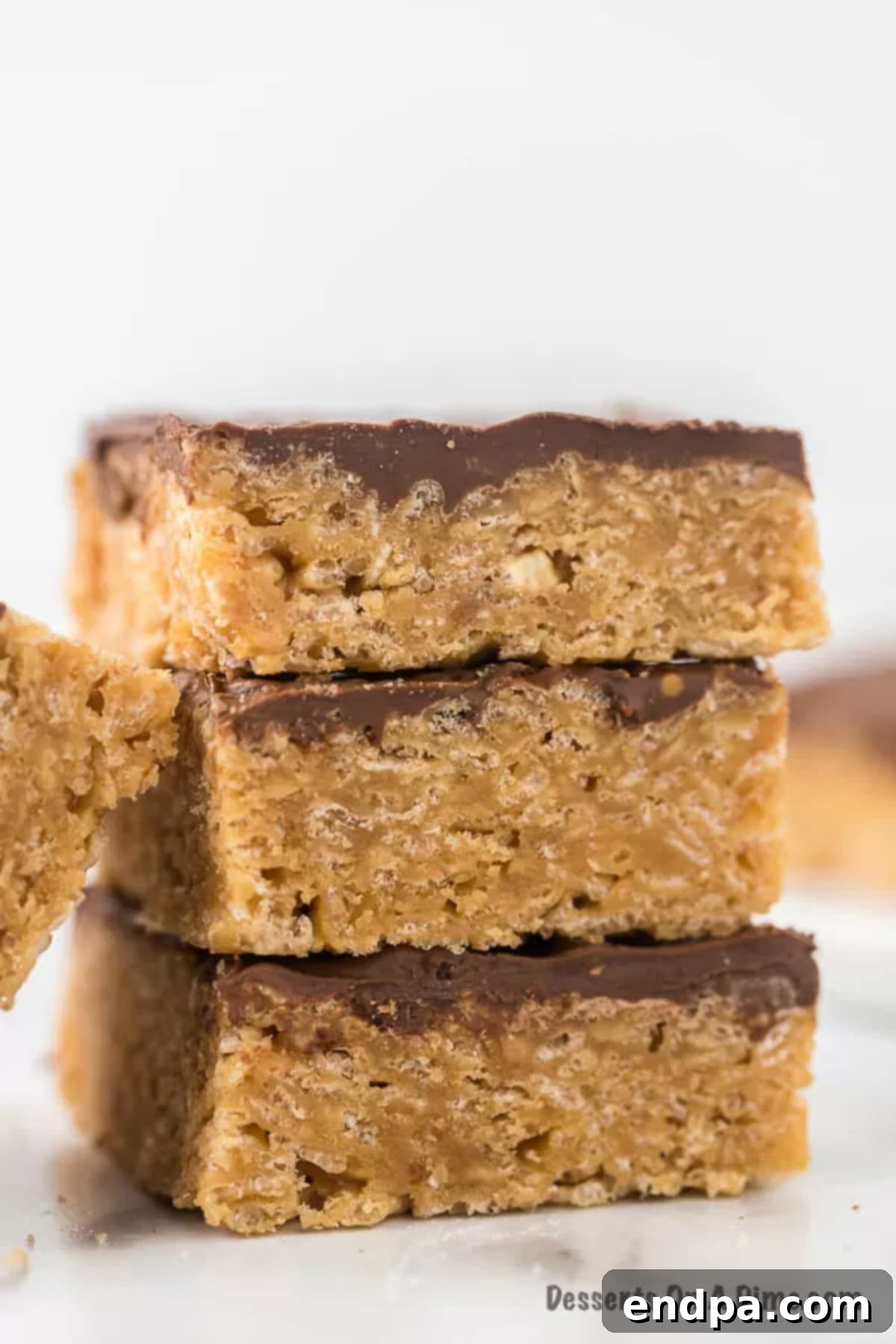 Perfectly cut Scotcheroos bars arranged on a serving platter, showcasing the glossy chocolate and butterscotch topping over the crisp Rice Krispies and peanut butter base.