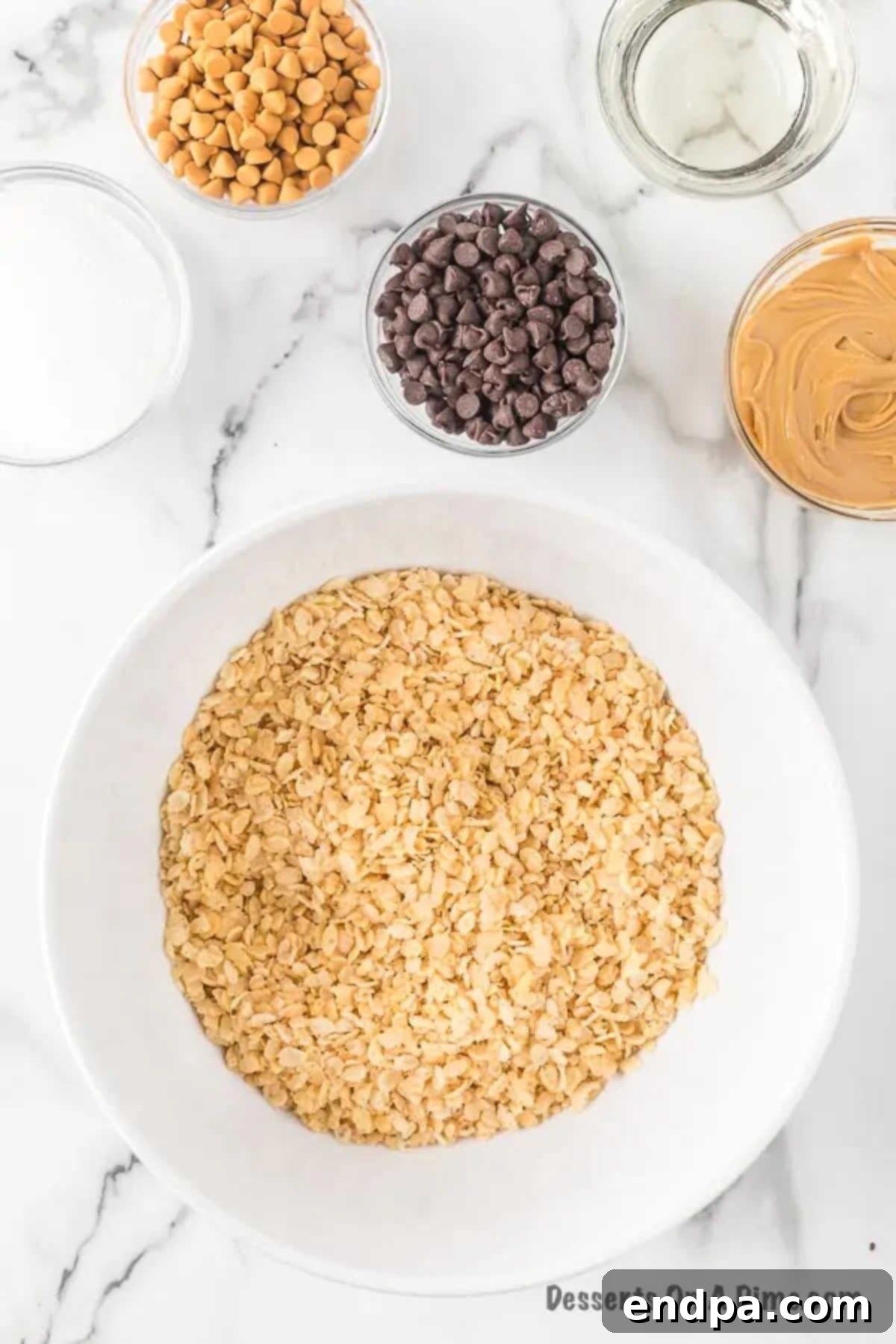 An empty large mixing bowl with Rice Krispies cereal ready to be poured in, highlighting the start of the preparation process.