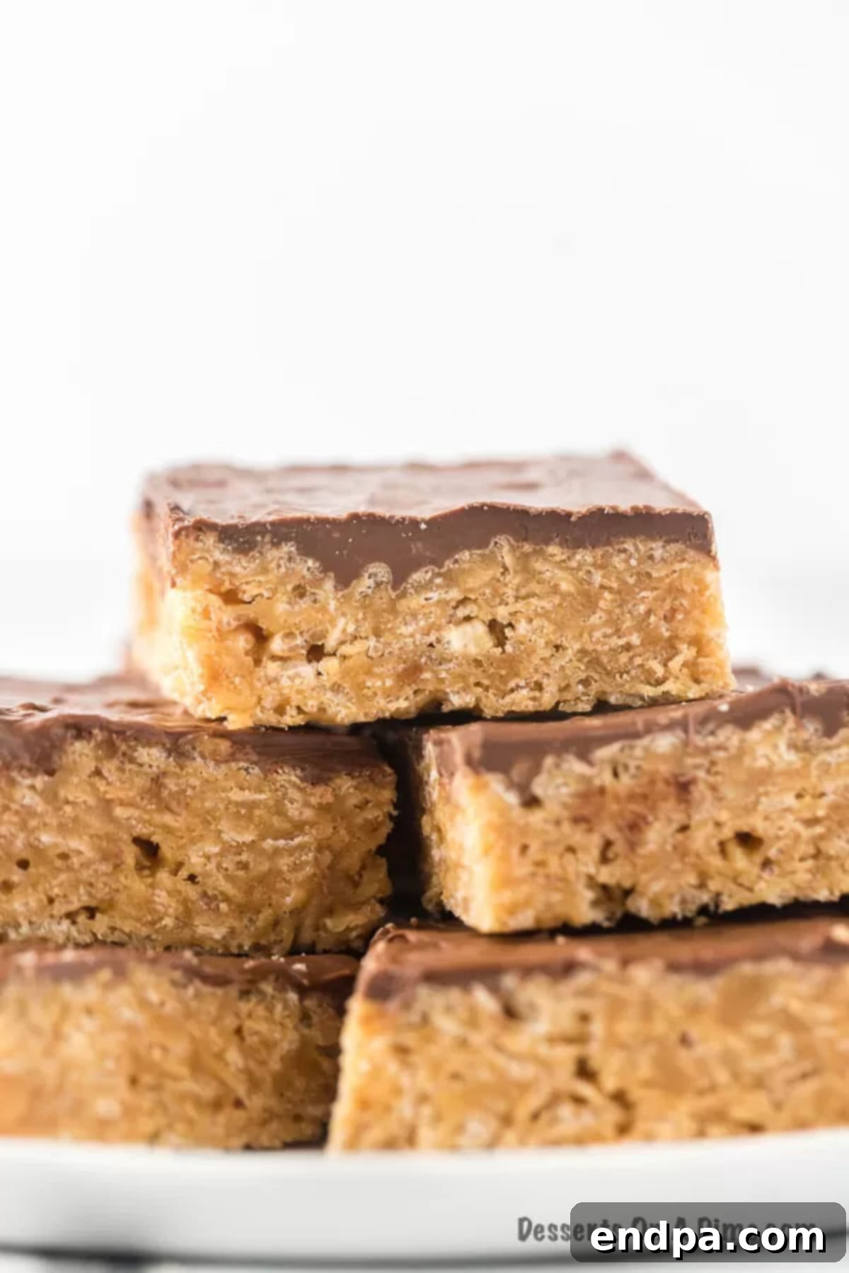 A platter adorned with several perfectly cut Scotcheroos bars, showcasing their distinct layers and inviting texture, ready for serving and enjoyment.