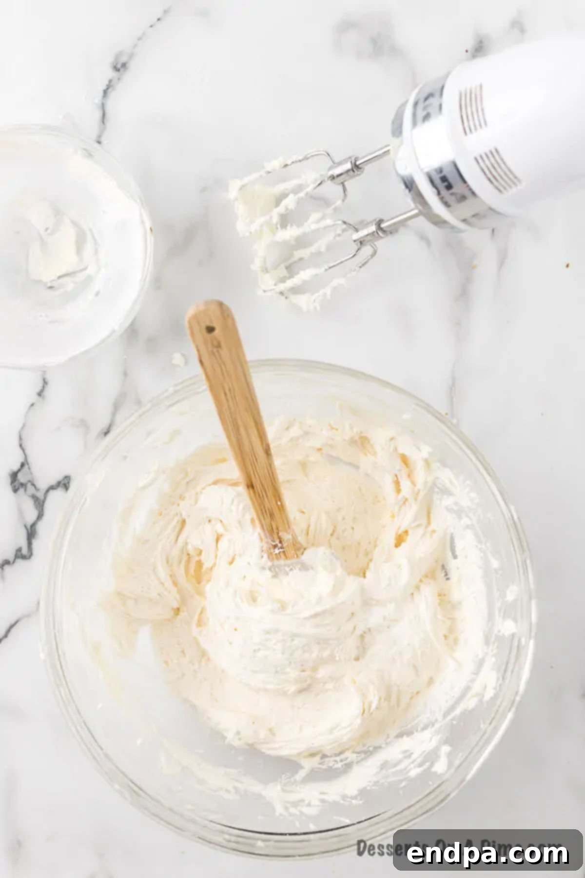 Combining softened butter and sifted powdered sugar in a large mixing bowl.