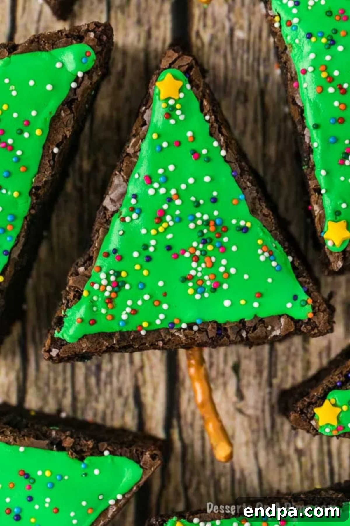 Beautifully decorated Christmas tree brownies arranged on a festive platter, ready to be served at a holiday gathering.