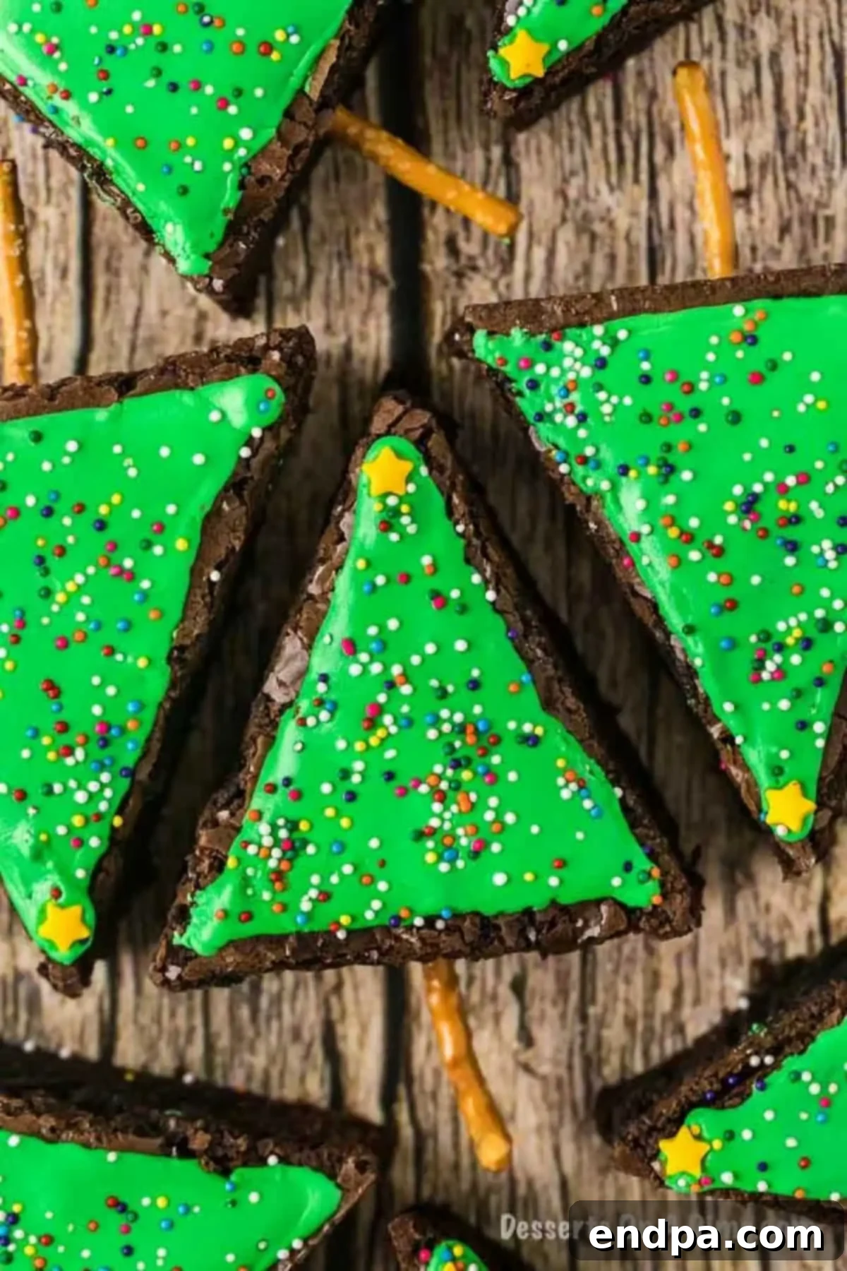 A collection of festive Christmas tree brownies, fully decorated and displayed, ready to be enjoyed as a holiday dessert.