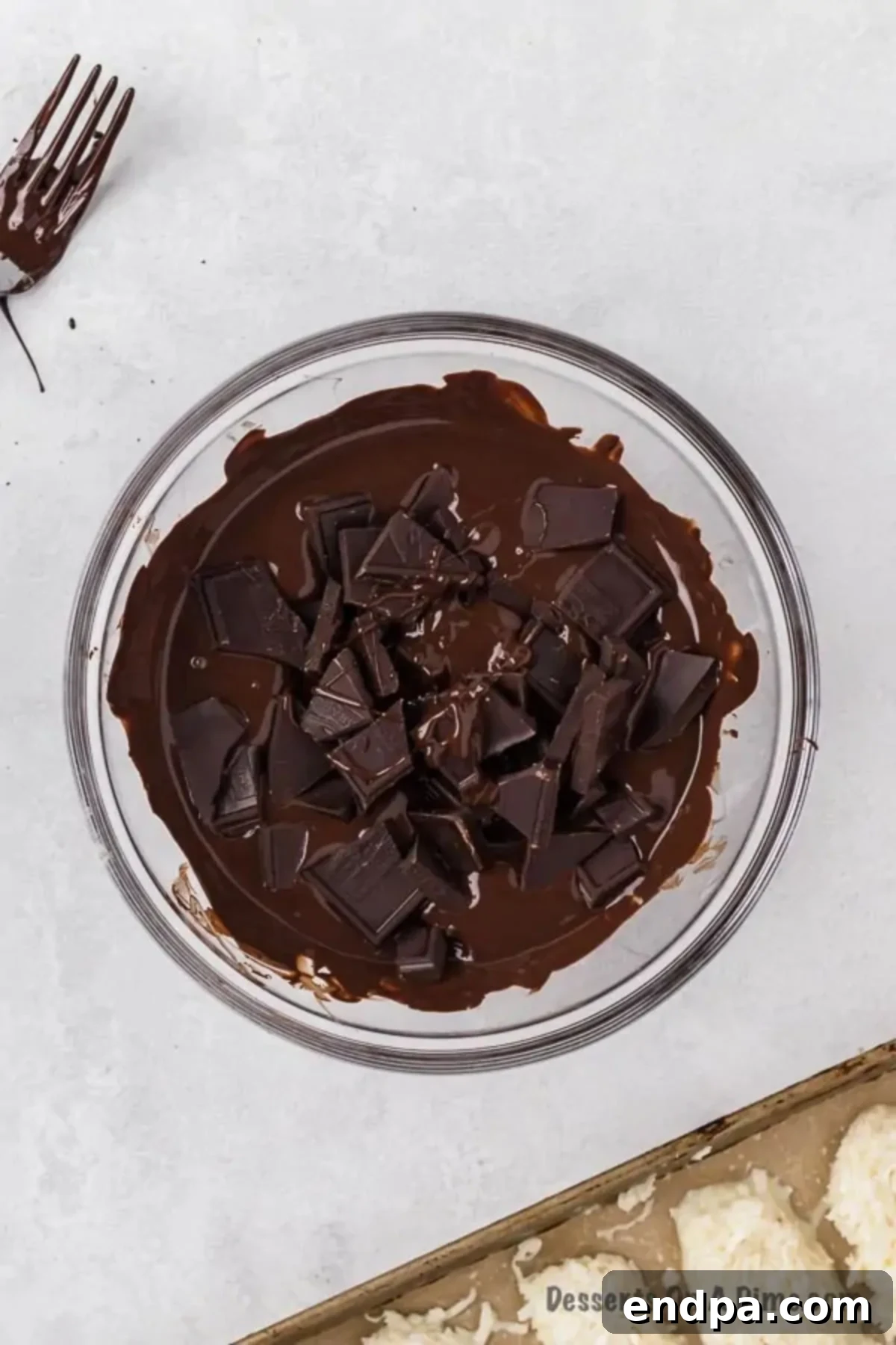 Decadent Homemade Mounds Bars 7 Chocolate chips melted in a microwave-safe bowl.