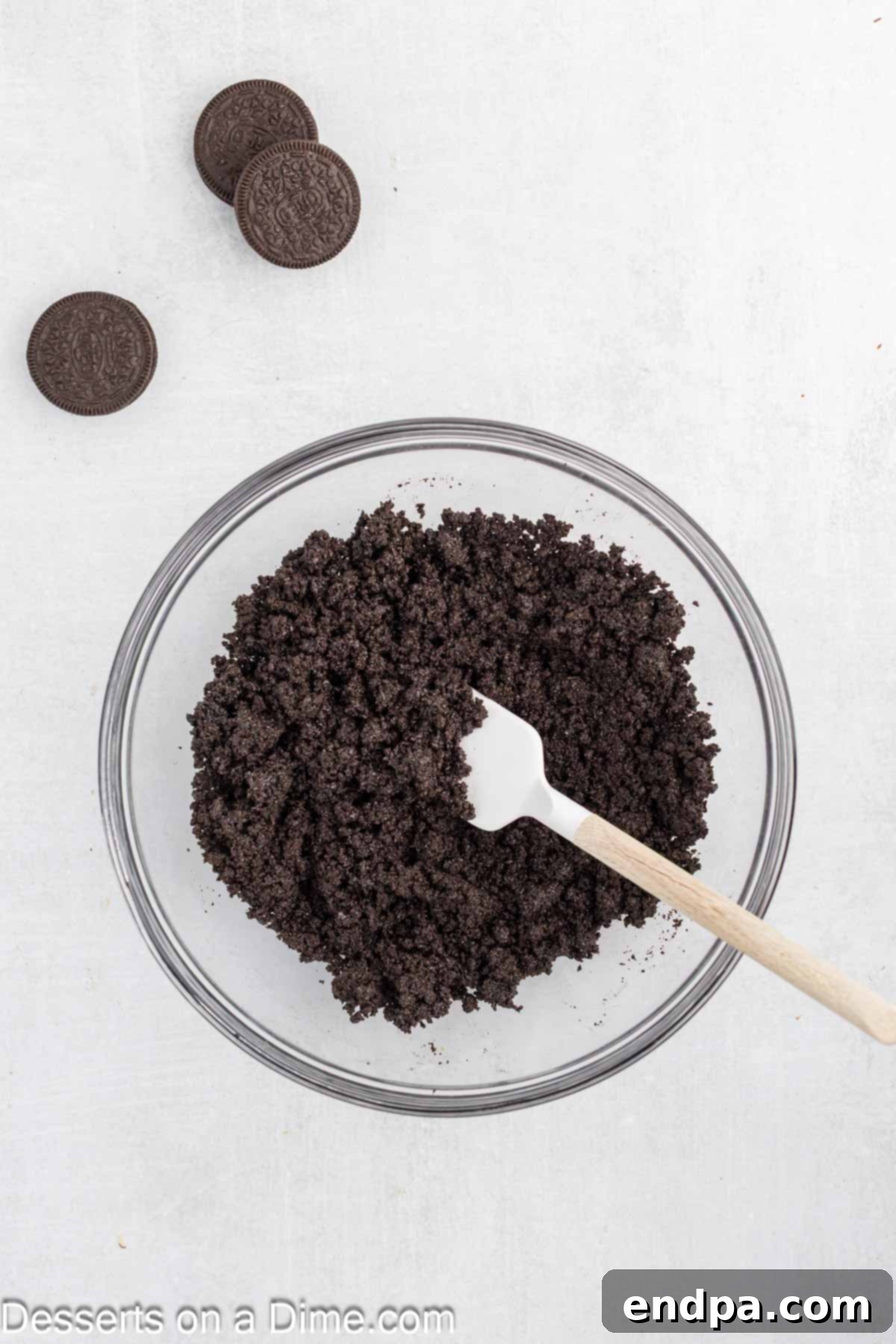 Hula Pie 4 Oreo crumbs in a bowl mixed together with melted butter for the Hula Pie crust.