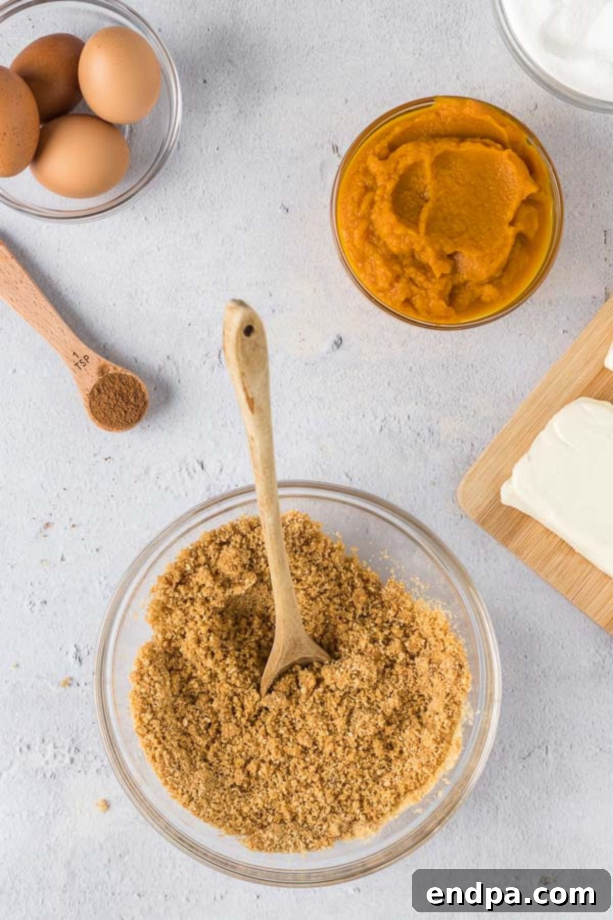 Spiced Pumpkin Cheesecake Bars 4 The graham cracker crumbs, brown sugar, melted butter and salt mixed together in a large mixing bowl.
