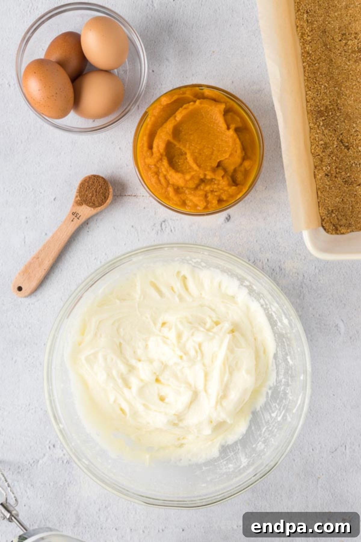 Spiced Pumpkin Cheesecake Bars 6 The cream cheese and sugar mixed together in a large mixing bowl.